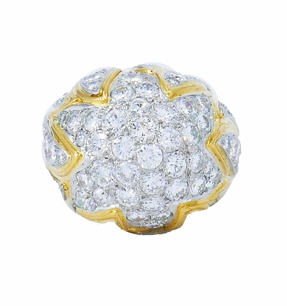 	A stunning vintage ring made of 18 karat yellow gold and diamond in a Bombe style. 
The ring is generously embellished with round brilliant cut diamonds set in white gold which accentuates their whiteness. The color of the gold makes the setting