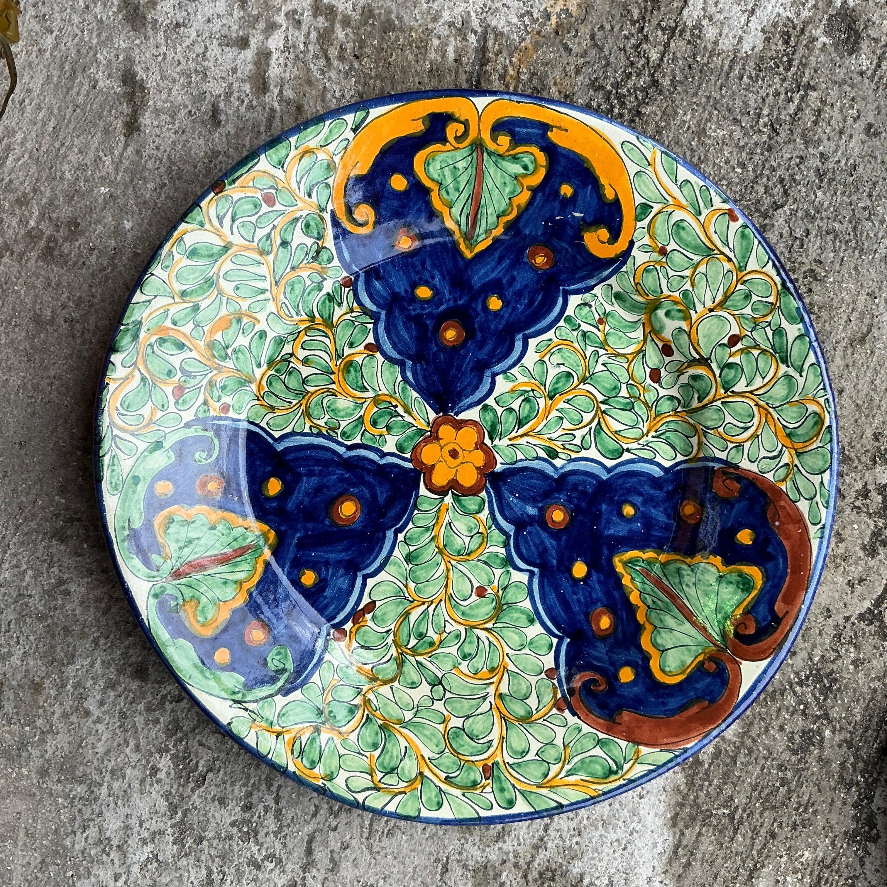 Add a stunning focal point to your table or wall decor with this Vintage Boho Hand-Painted Glazed Ceramic Platter. Featuring intricate, hand-painted patterns in vibrant colors, this platter brings an artisanal charm that instantly enlivens any