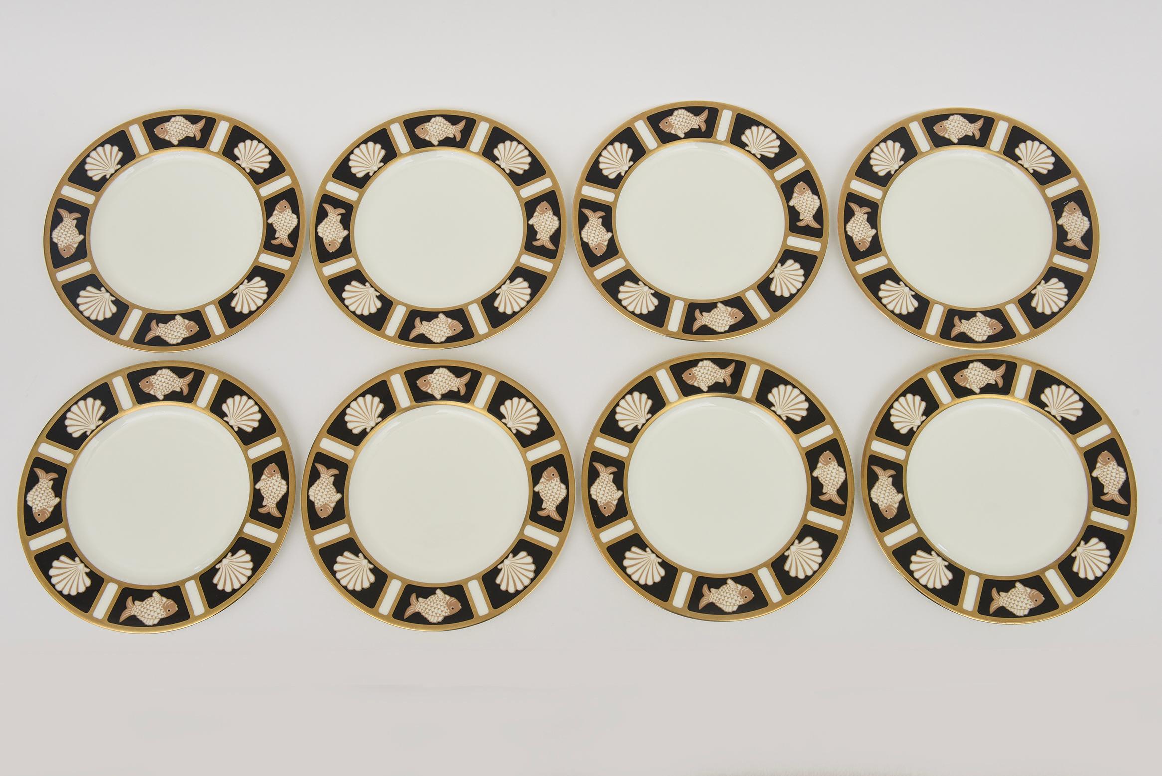 This lovely and elegant set of bone vintage serving, appetizer or salad plates are by Narumi Porcelain Co. from Japan. The design motif are alternating images of shell and fish. The are a set of 8. From the 60;s. The colors are white, tan and black.