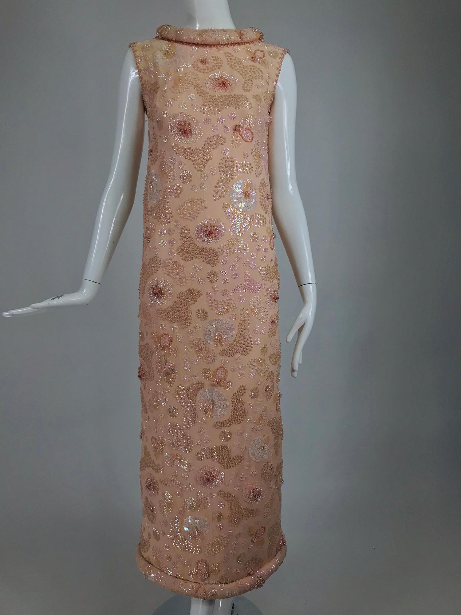 Vintage Bonwit Teller Pale Pink Beaded Sequin Demi Couture Gown from the 1960s. A style made famous by Jackie O in her early White House years. Gorgeous pale pink chiffon over satin, sleeveless A line gown with a stand away hand padded, rolled and