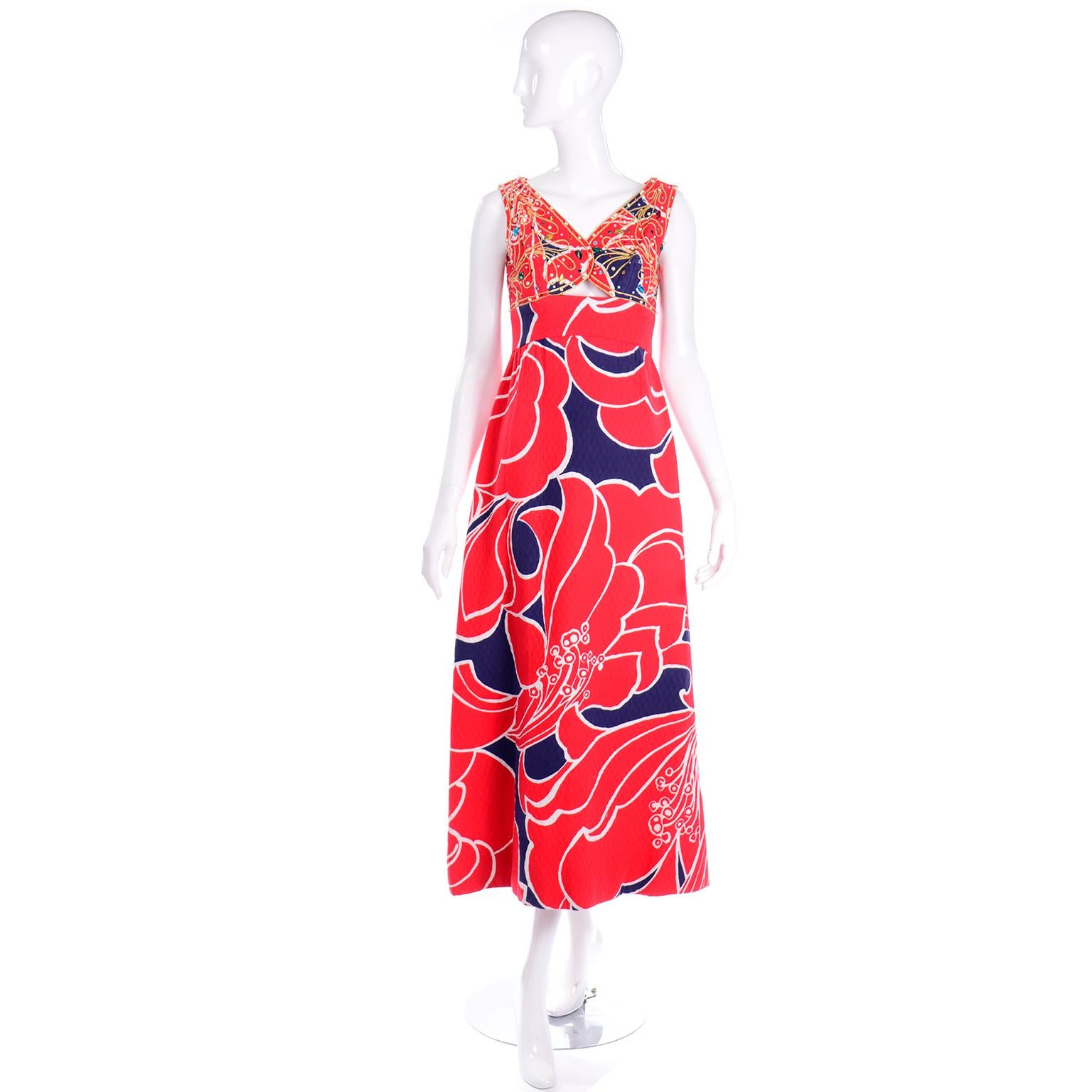 This vintage red, white, and blue cotton sleeveless maxi dress is so gorgeous! This Bonwit Teller maxi dress has incredible colorful jewels and gold embroidery throughout the front and back of the bodice. We love the peek a boo small triangle