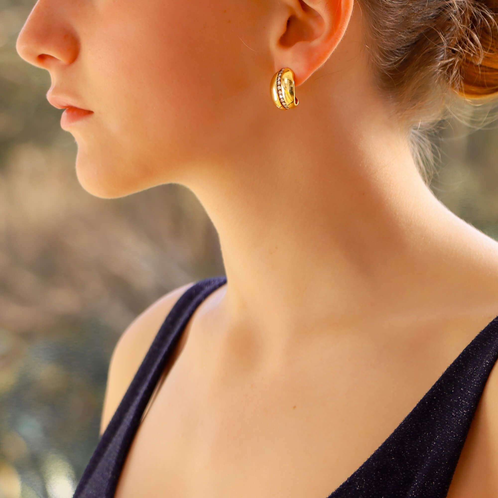 A sensational pair of vintage Boodles diamond leaf earrings in 18-karat yellow gold. 
Each earring is designed as a stylized curved leaf, set to the centre with a row of grain-set round brilliant-cut diamonds amidst a polished yellow gold leaf. They