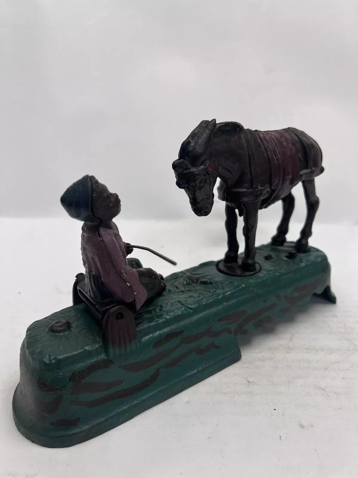 Vintage Book Of Knowledge Cast Iron Mechanical Horse Kicking Boy Bank. Circa Late 20th Century. Measurements: 5.5