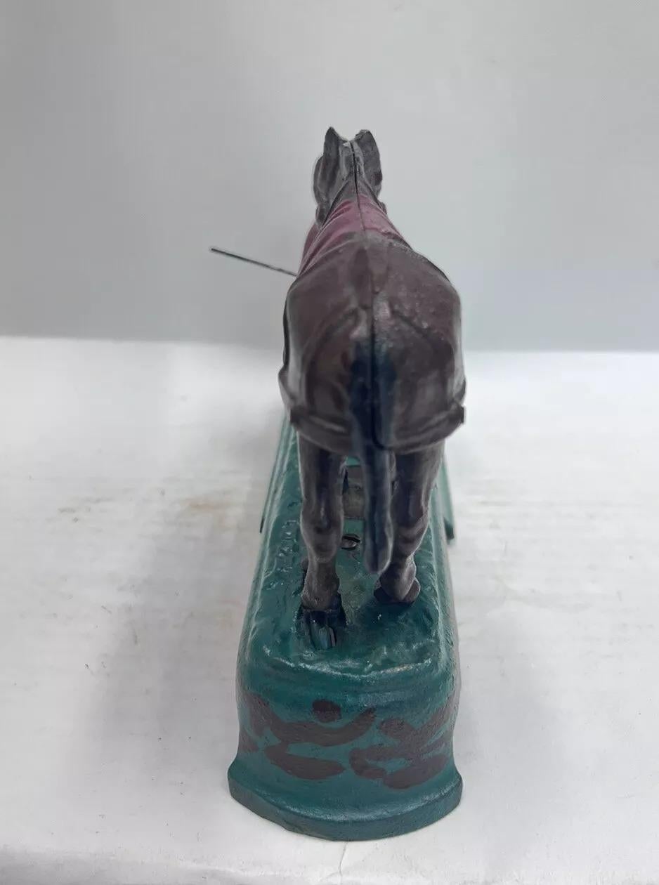 20th Century Vintage Book Of Knowledge Cast Iron Mechanical Horse Kicking Boy Bank For Sale