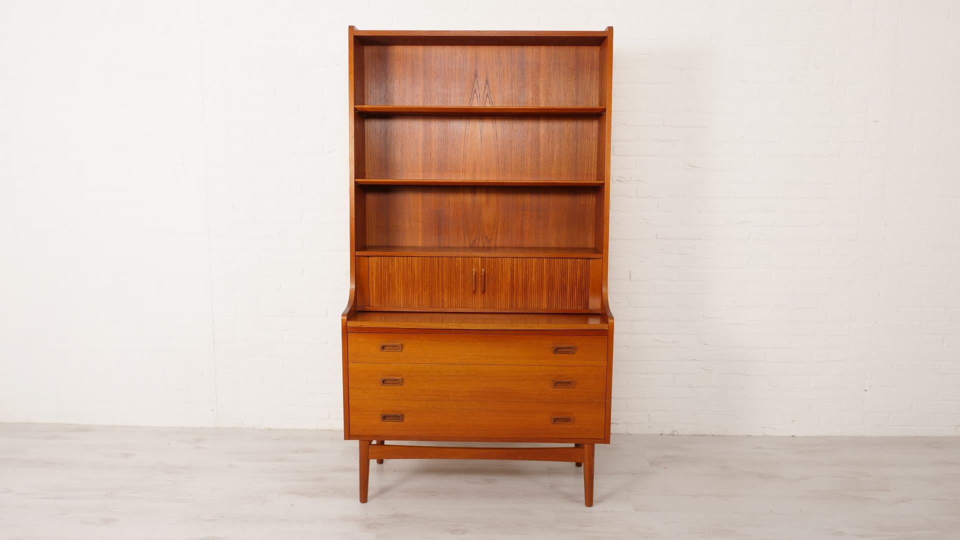 Beautiful vintage bookcase from the 1960s, from Denmark, designed by Johannes Sorth. The vintage cabinet has 3 shelves at the top that are beautifully finished, at the bottom you will find 2 small sliding doors with 3 spacious drawers