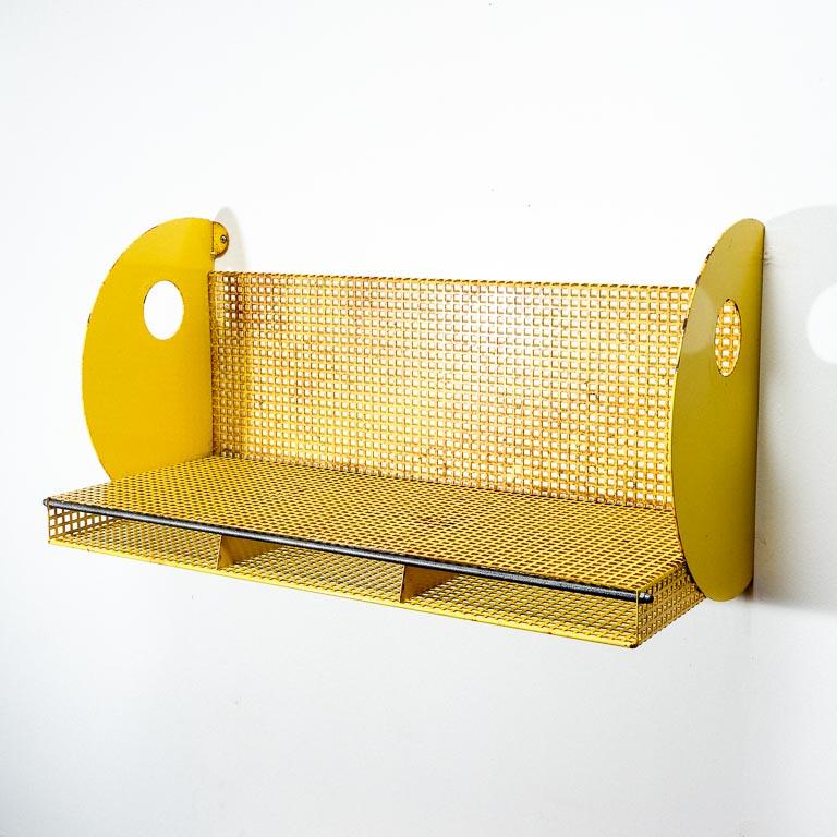 Vintage wall-mounted bookshelf attributed to Mathieu Mategot for Pilastro, Holland. Perforated steel with big 