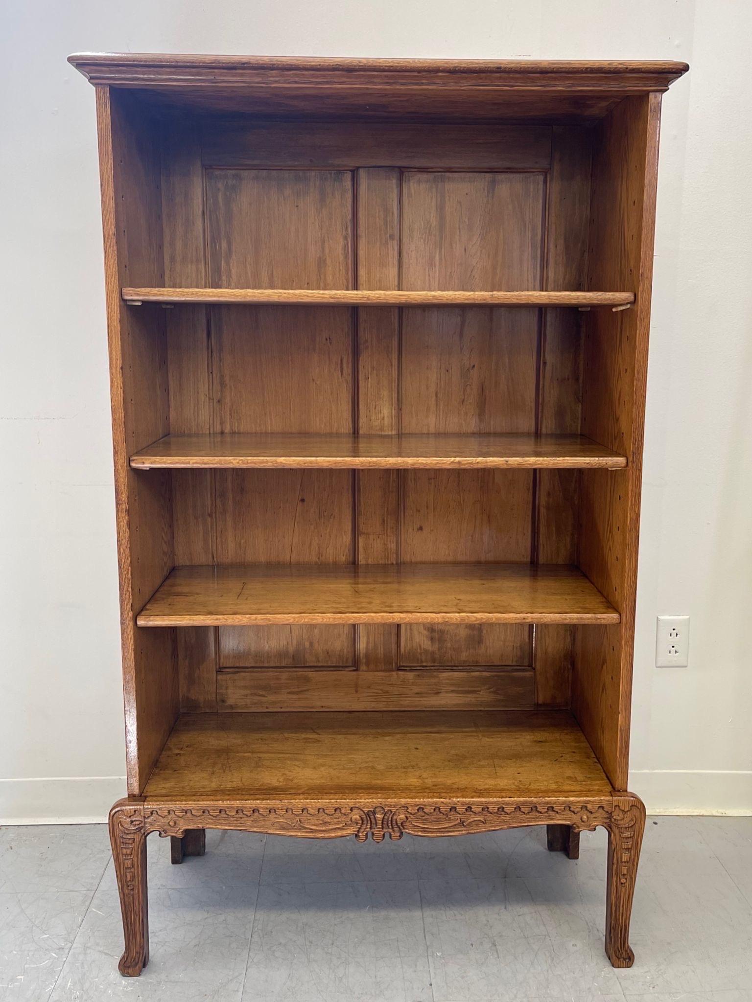 This Bookshelf has adjustable shelving and a carved wood base. Antique style. Beautiful Patina to the wood. Vintage condition consistent with age as Pictured.

Dimensions. 32 W ; 13 D ; 57 H