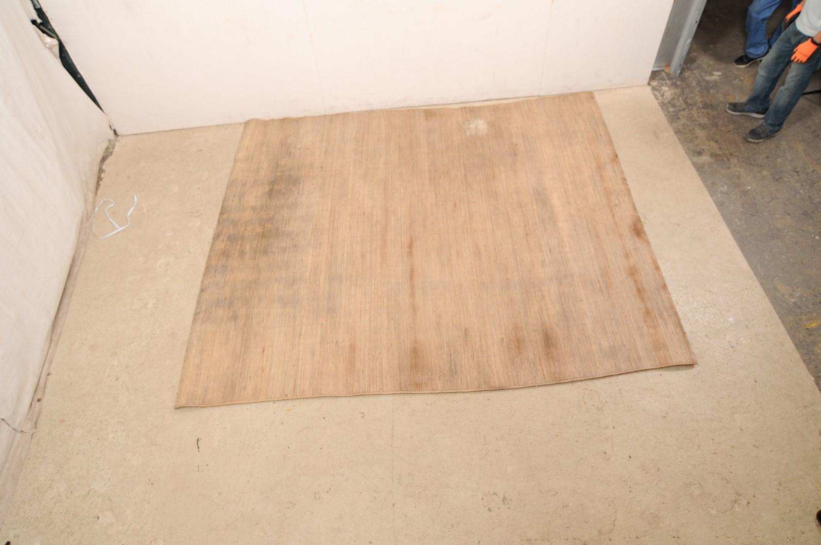 A Malaysian hand-crafted bamboo reed floor mat. This vintage bamboo mat would have originally graced the floors in a Dayak long-house in Borneo; an artisan created piece which is signed by its maker. This nicely sized mat is just shy of 10 feet in