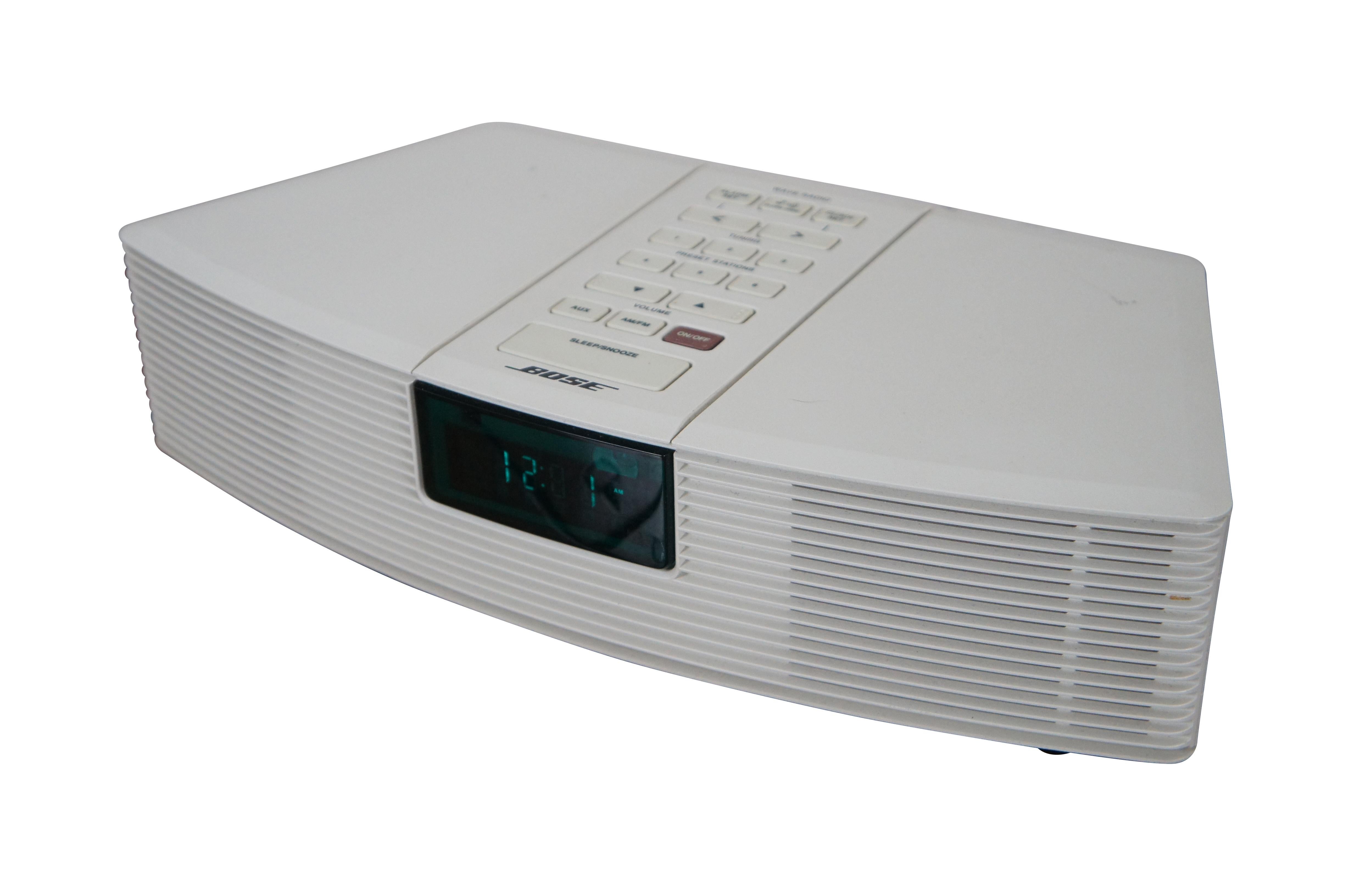 Vintage 1990’s Bose Wave Radio alarm clock in white with 6 station pre-sets, AM/FM stereo, aux inputs and remote control. Model AWR1-1W. Serial Number: 018815C8167 3207A

DIMENSIONS

14.25” x 8.25” x 4” (Width x Depth x Height)