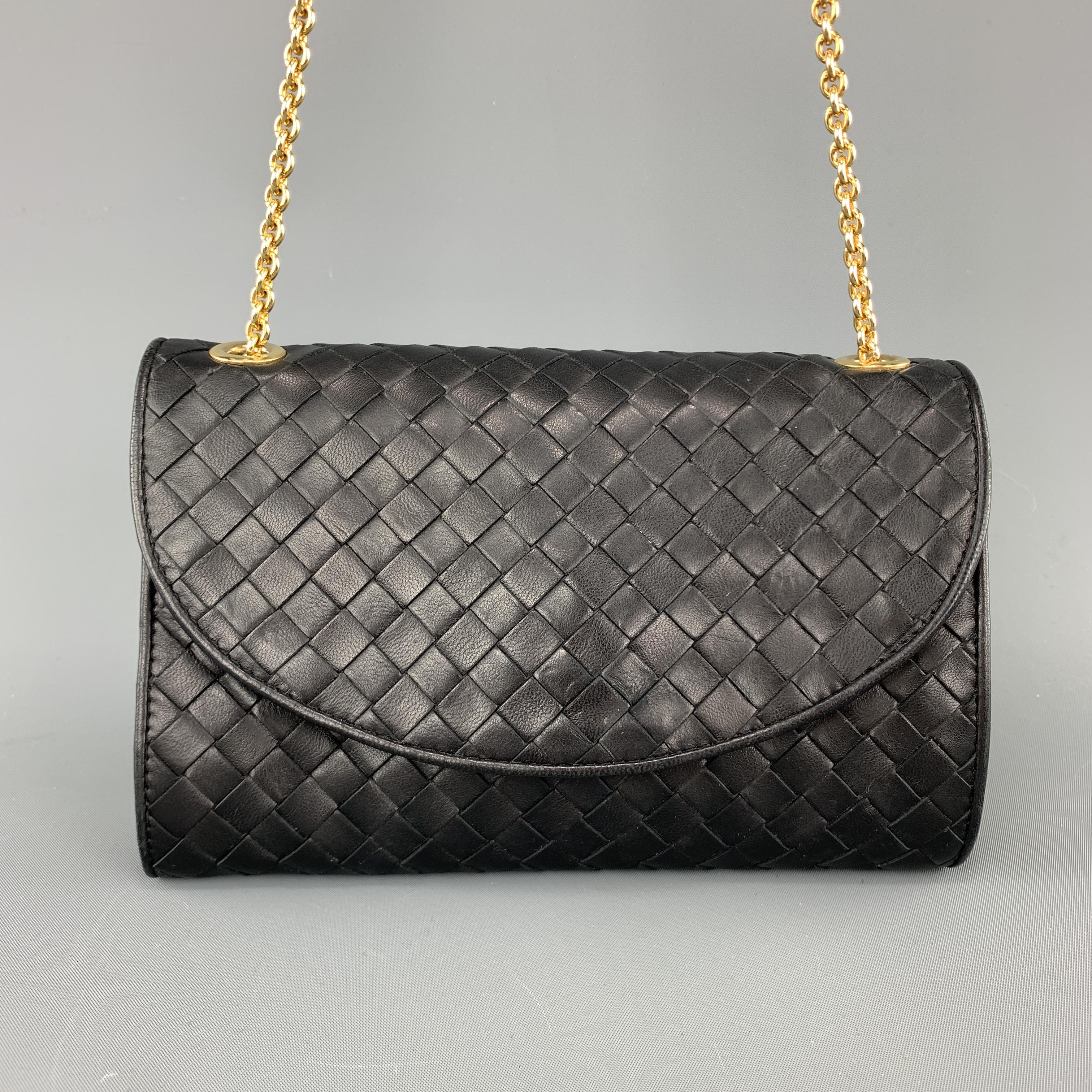 Vintage BOTTEGA VENETA bag comes in black woven intrecciato leather with a flap snap closure, Gold tone chain strap, and beige interior. Lining in poor condition. As-is. Made in Italy.

Good Pre-Owned Condition.

Measurements:

Length: 7.75
