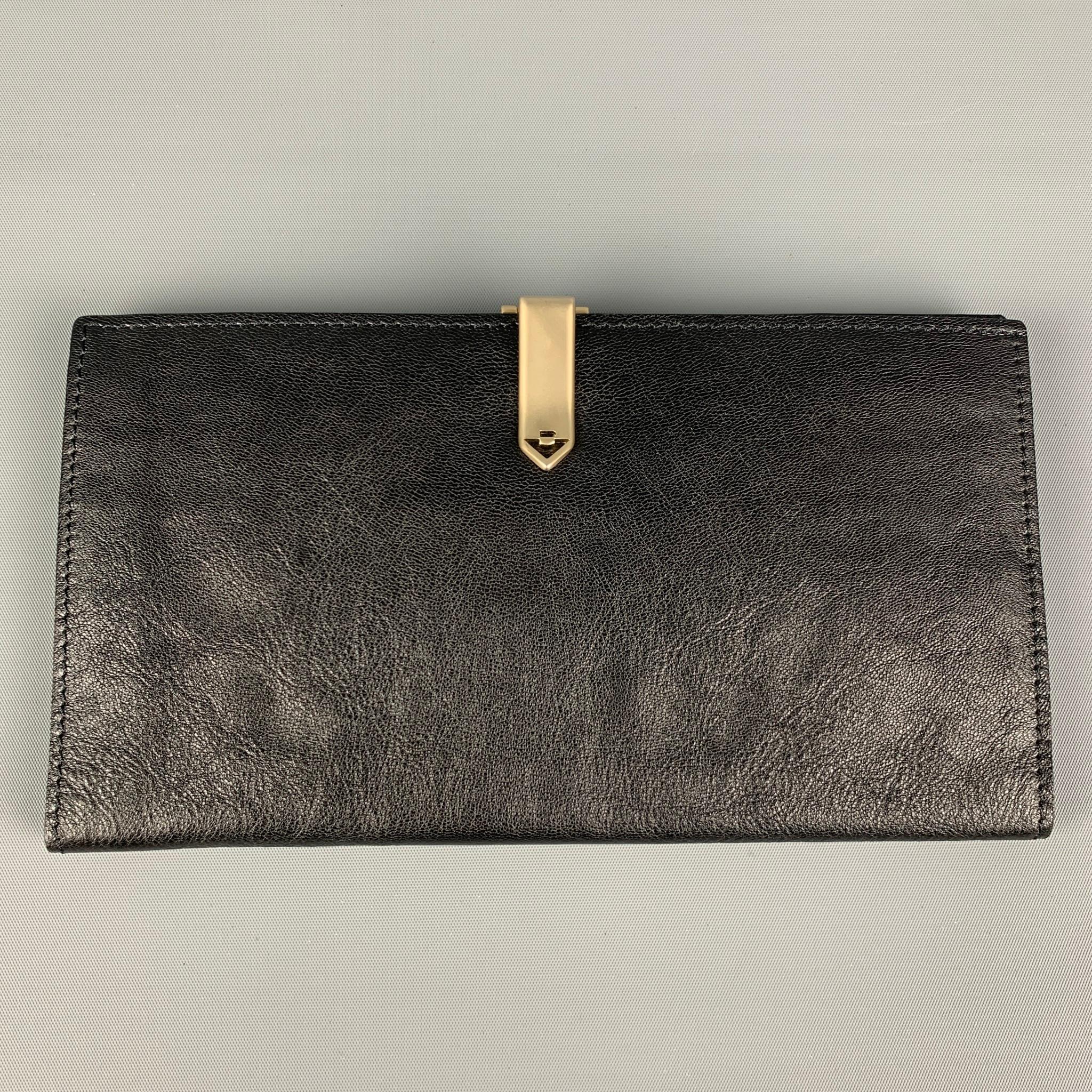 Vintage BOTTEGA VENETA wallet comes in a black woven leather featuring inner card slots and a silver tone clasp closure. Includes dust bag. Made in Italy. 

Very Good Pre-Owned Condition.

Measurements:
Marked: 32557825365NE

Length: 7.25