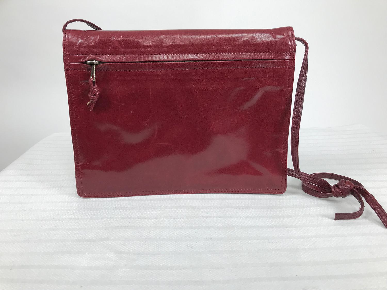 Vintage Bottega Veneta soft burgunday glazed leather envelope shoulder or clutch bag from the 1970s. Envelope bag with gusseted sides will expand to hold more than expected. The bag closes at the front with a hidden snap beneath the faux slip tab.