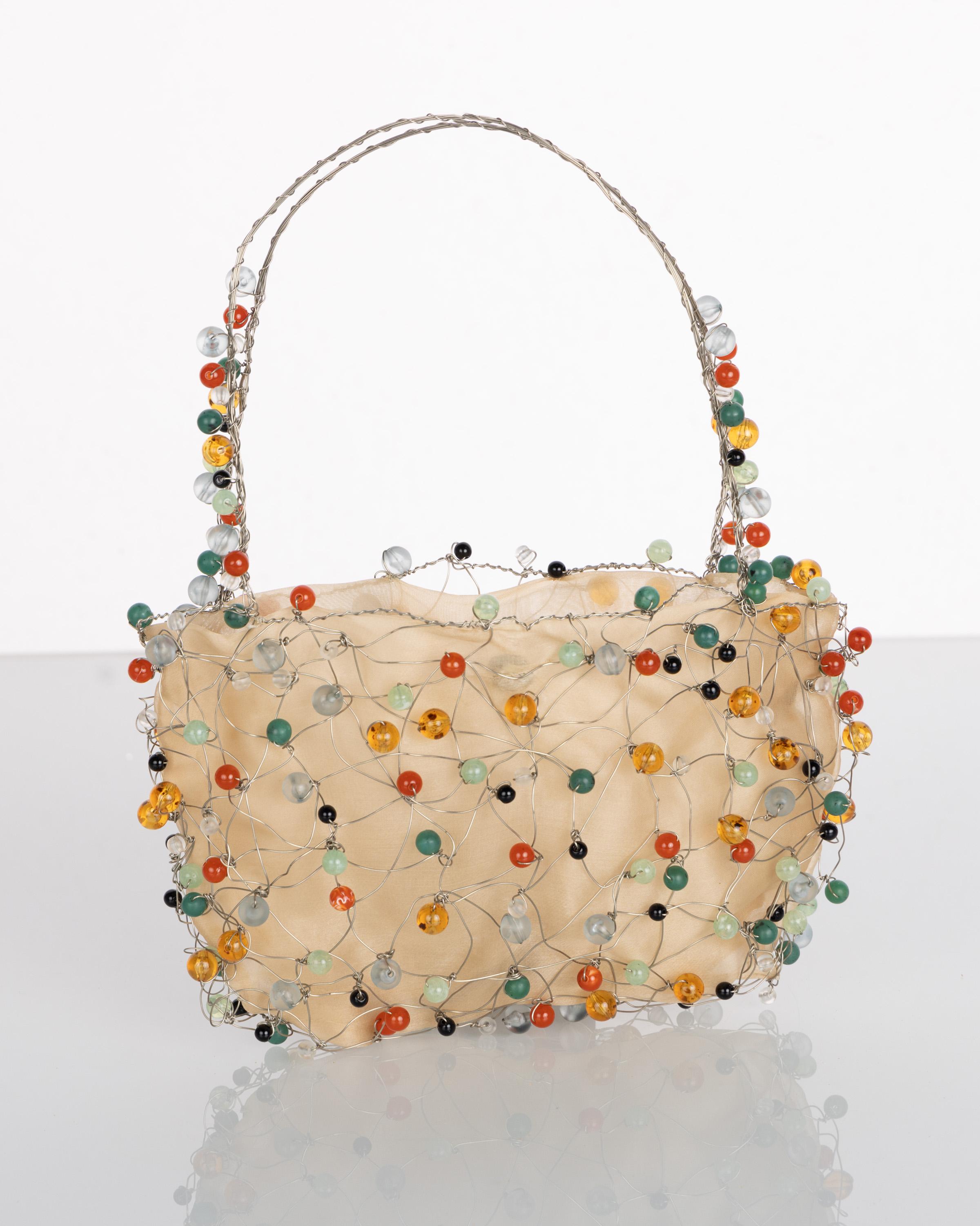 Beaded handbags were all the rage for much of the 19th century. Called reticules, these small bags would carry only the barest of necessities and tended to be more of a decorative accessory than functional. This version by Bottega Veneta