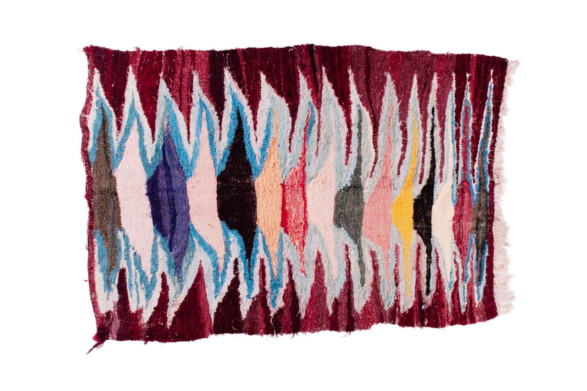 Boucharouite rugs are made of multicolored clothes pieces. This is the most authentic recycled rug you've ever seen! Measurements: 4'х6' / 182x125 cm.

Boucharouite – is the ancient manual technique of tying and interweaving the multicolored clothes