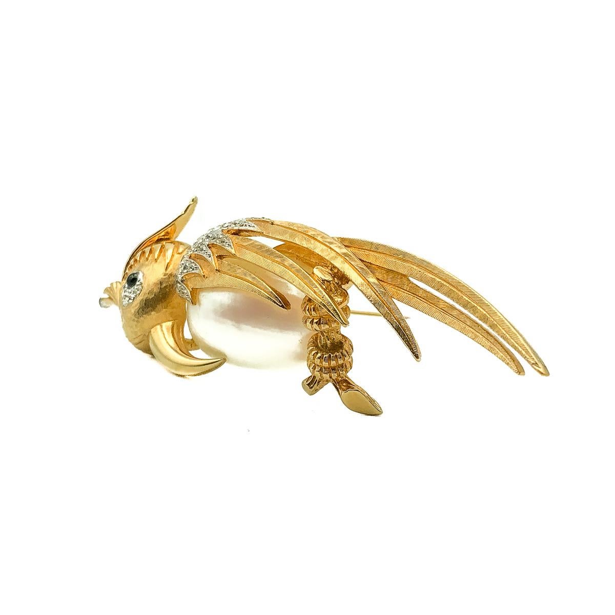 Vintage Boucher Cockatoo Brooch. Crafted in gold plated metal, mother of pearl and crystals. An impressive and large bird design pin, inspired by a Cockatoo. Embellished with a wonderful and large mother of pearl belly and adorned with crystal