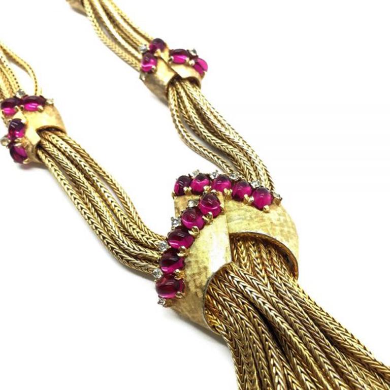 An exceptionally rare and wonderful signed vintage Boucher Sautoir Necklace made in America by Boucher between 1955 and the early 1960s. The sautoir comprises six strings of gilt box chain adorned with six beautiful accent pieces. These accent