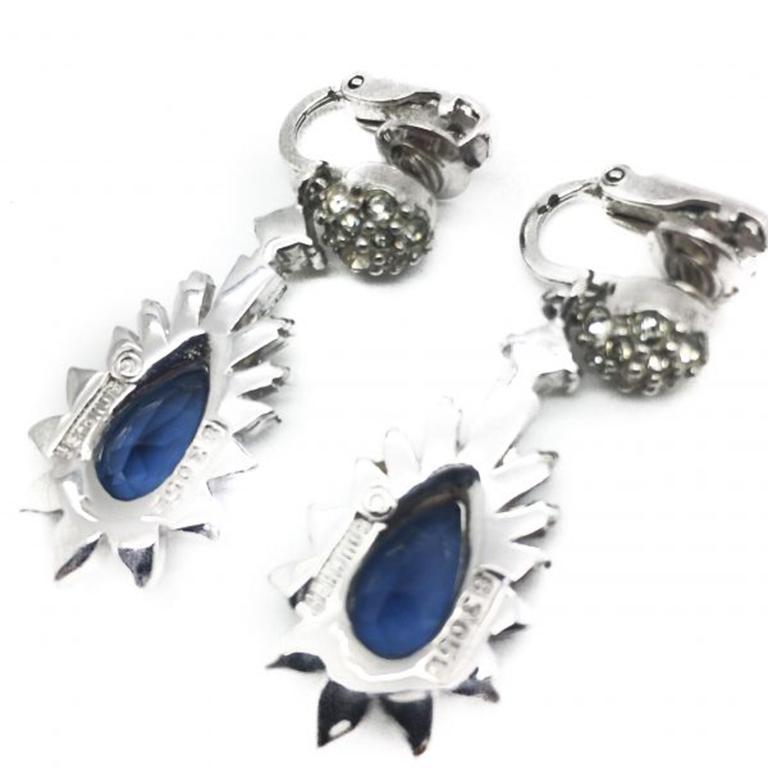 A wonderful pair of Blue Boucher Earrings. Made in the 1950s and with fabulous style and craftsmanship. Featuring baguette crystal stones set around a divine deep blue teardrop faceted crystal and hand set in rhodium plated metal, these are a very