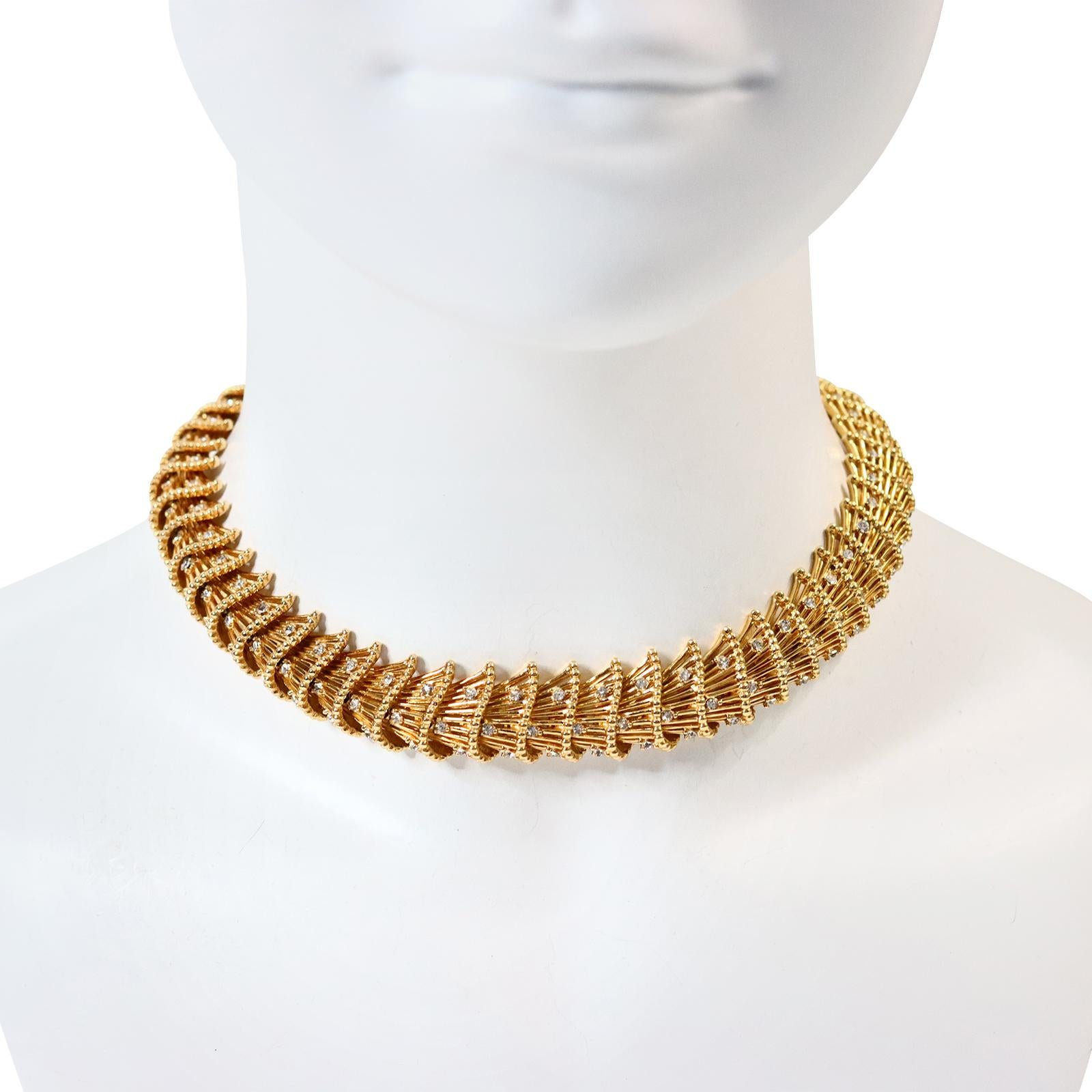 Vintage Boucher Gold and Crystal Fan Like Necklace Circa 1960s.  Fan like pieces with round stones fall into place onto the next one in a pattern that forms this beautiful classic or edgy necklace.  Depends on the way you look at it. Hard to believe