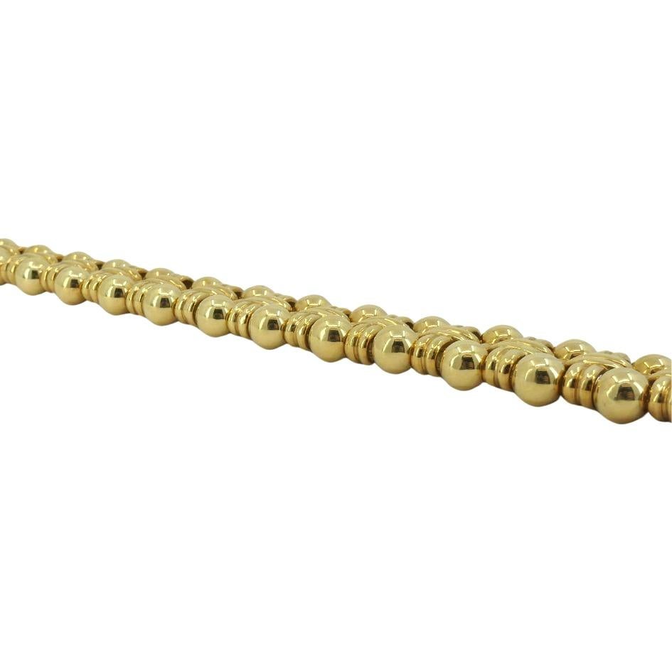 This vintage Boucheron bracelet, crafted in 18k gold circa 1970s, is a striking piece of luxury design. Weighing 49.5 grams, the bracelet measures 7 1/8 inches in length and 1/2 inch in width. The design features an intricate combination of gold