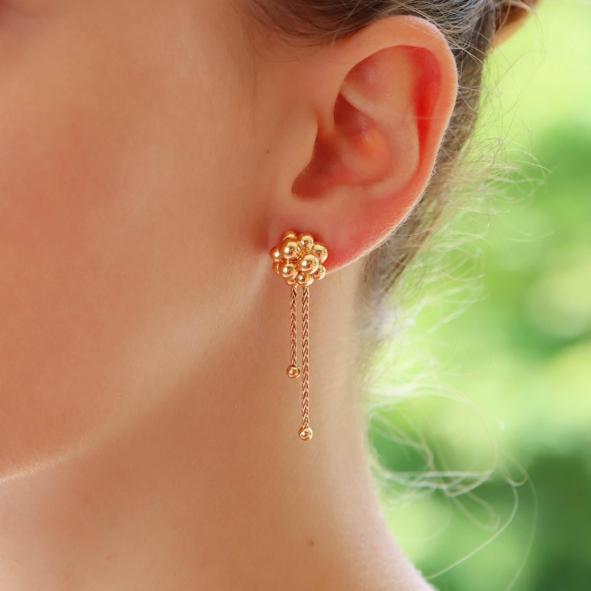 A unique pair of vintage Boucheron ‘Grains De Mure’ drop earrings set in 18k rose gold.

Each earring is firstly composed of the iconic Boucheron ‘Grains’ bubble motif. The motif is composed of a number of bubbles which looks fantastic once on the