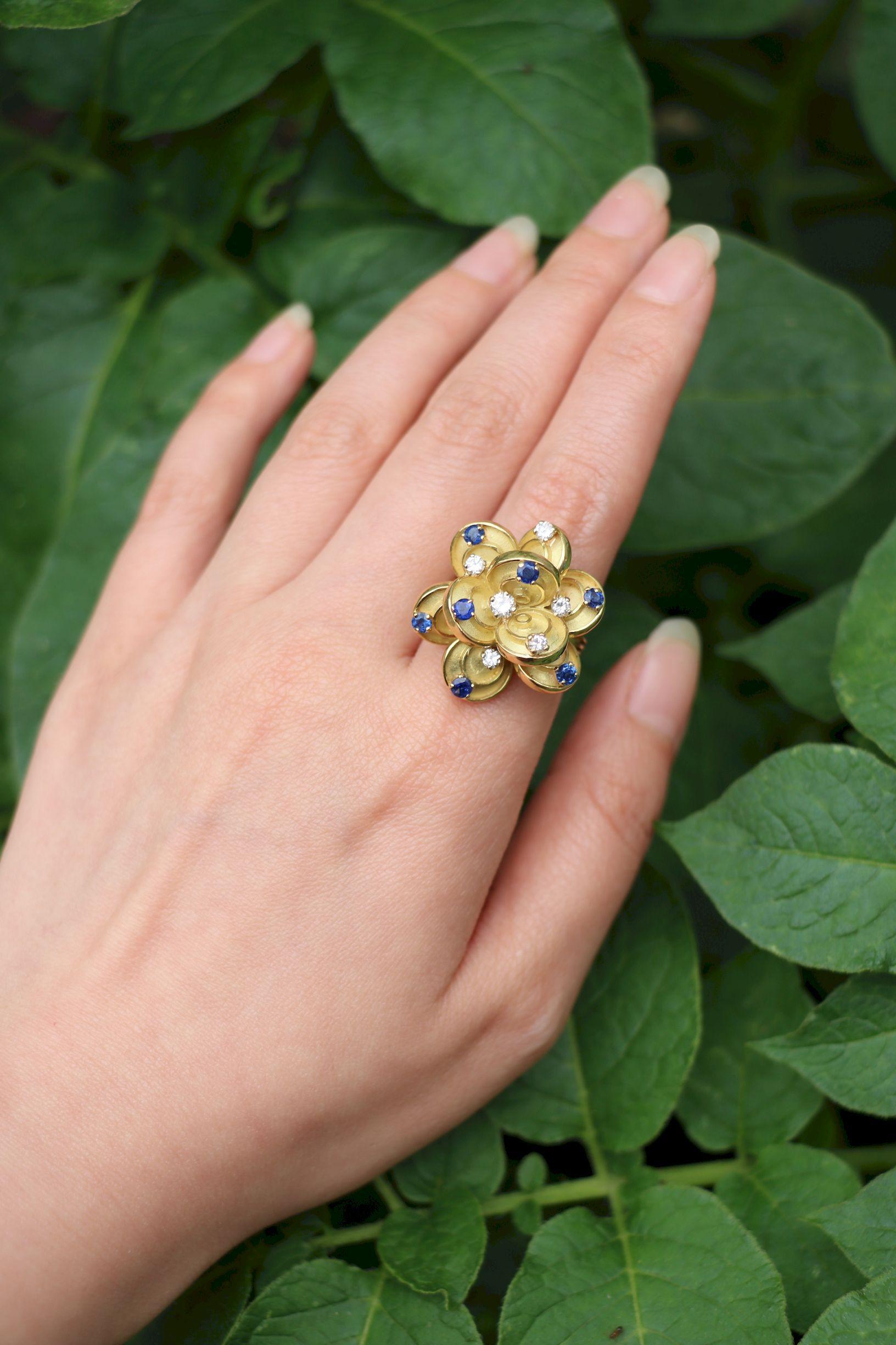 Vintage Boucheron Paris 18K Gold Diamonds Sapphire Flower Ring

Marked:
Boucheron Paris

Approximate Dimensions:
5.5 (Ring Size) 
Approx. 0.56 carats (Sapphire)
Approx. 0.3 carats (Diamond)
D, VS1 (Diamond)
18.2 grams in weight.

** All dimensions