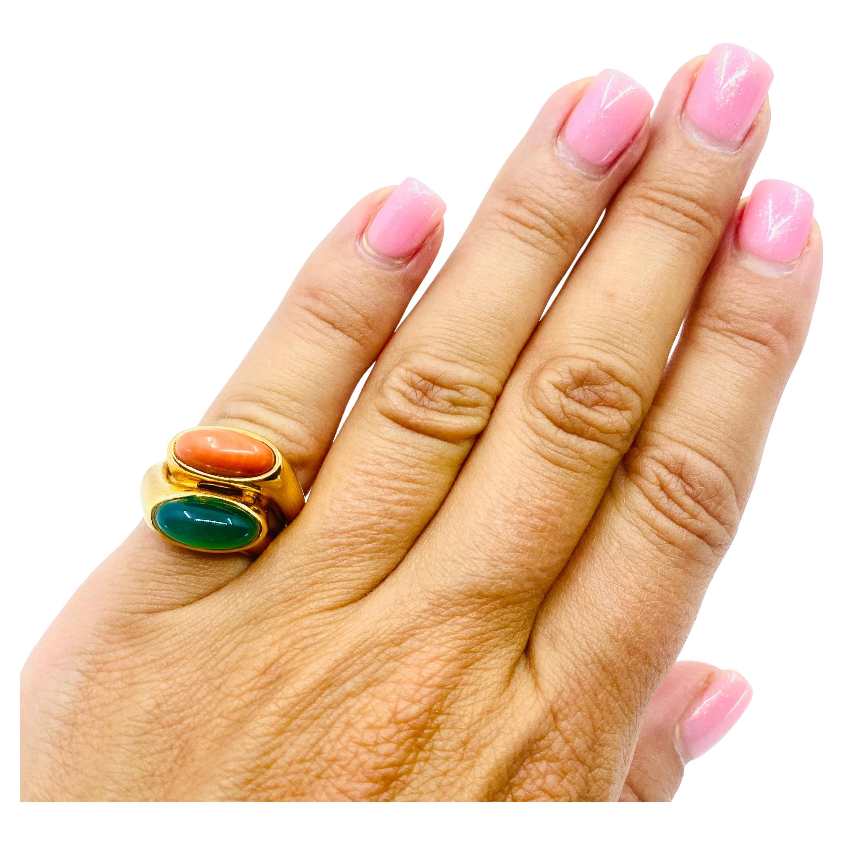 A colorful Boucheron ring made of 18k gold, features chrysoprase and coral. The gem and the coral are both cabochon cut, set one above another. The double shank design provides to this “layering” a great look. Two bright, contrasting colors make