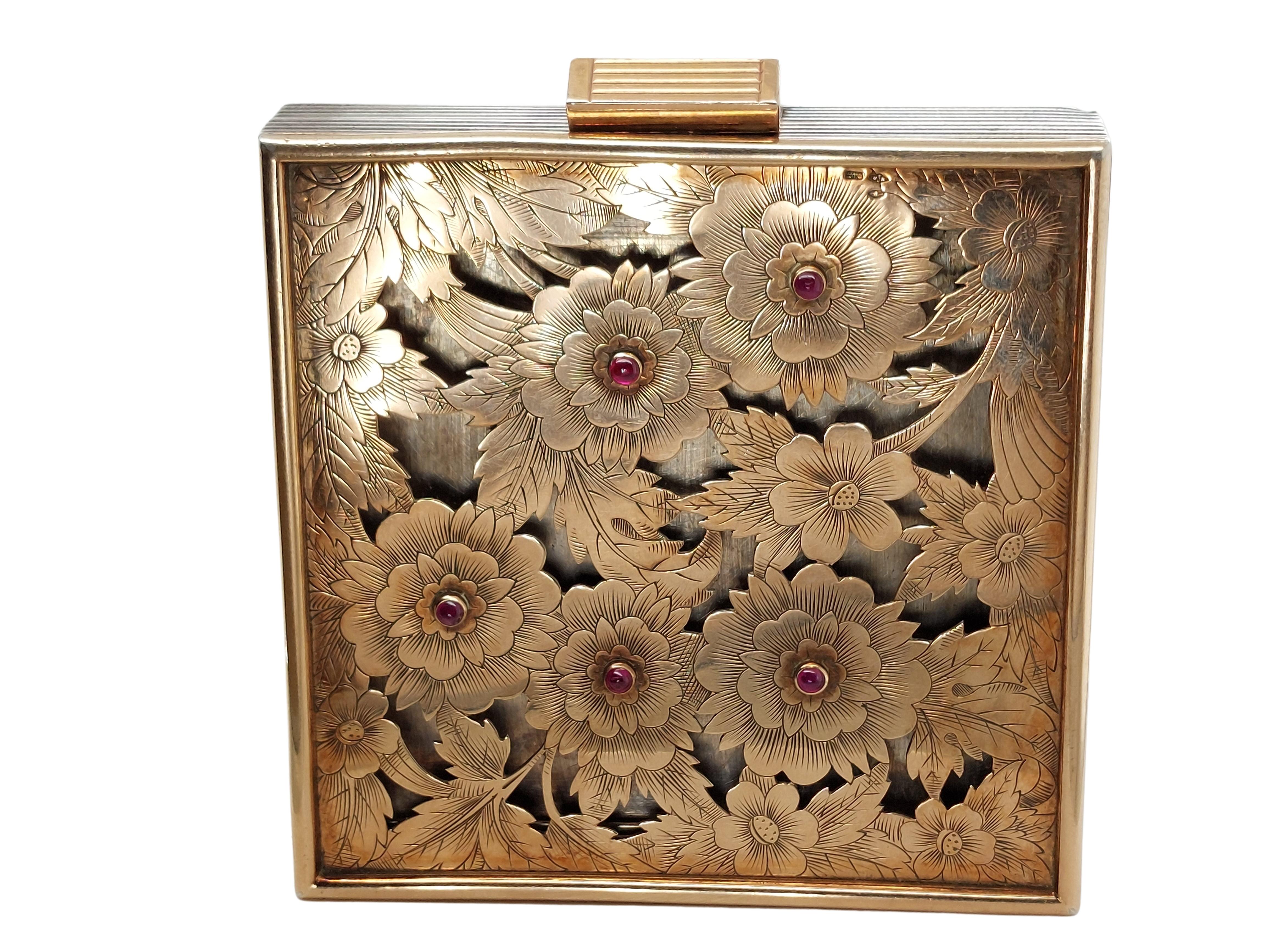Vintage Boucheron Gold and Silver Minaudiere Clutch 

Boucheron, 18 karat rose gold and sterling silver Minaudiere, studded with cabochon-cut rubies. The top of this opulent purse is 18 karat gold, pierced and engravings surrounded by ruby-studded