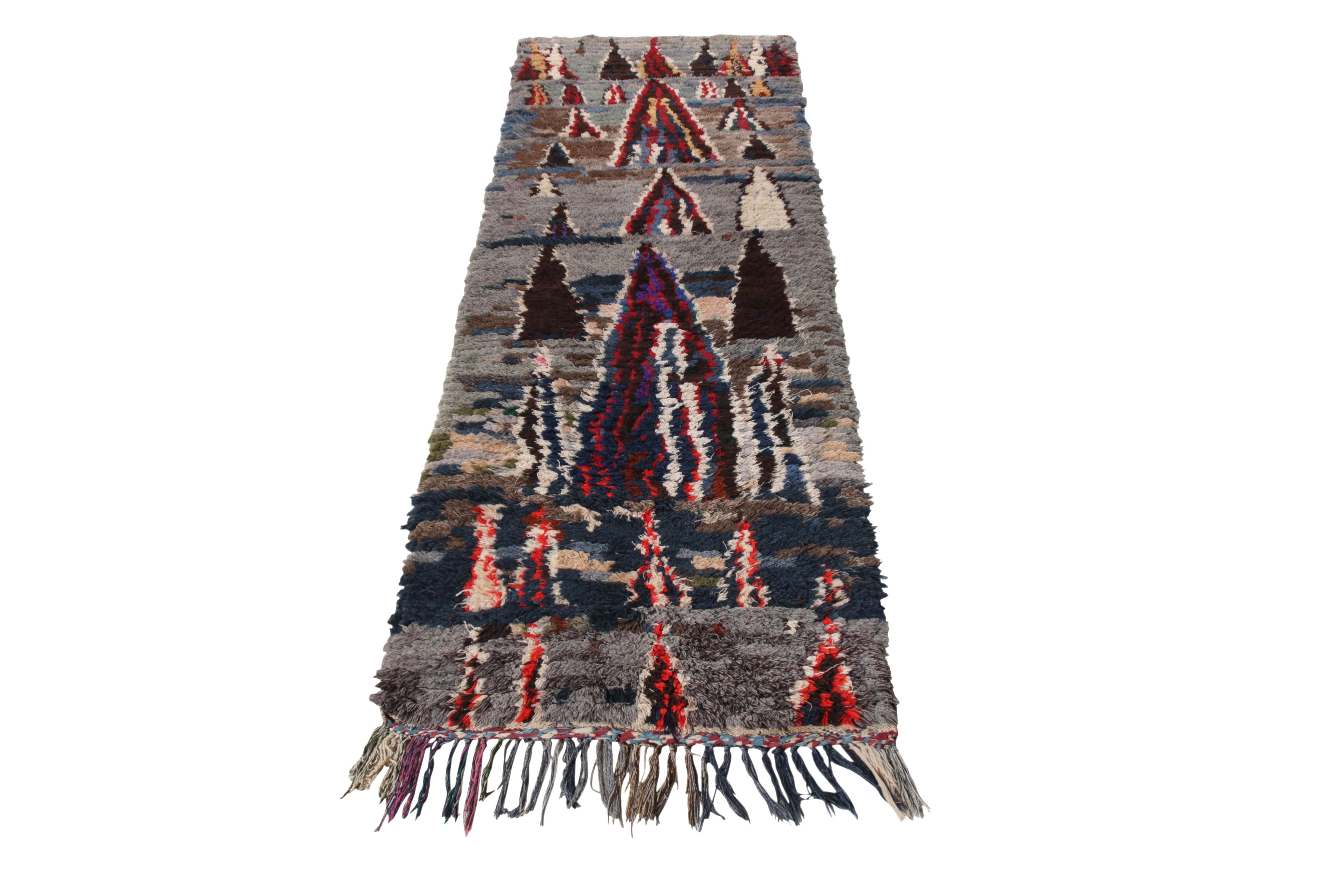 Hand knotted in Boucherouite wool & fabric, a 3x9 Berber Moroccan runner from the Moroccan collection by Rug & Kilim. Originating from Morocco circa 1950-1960, the runner is created in a high pile featuring an incredible tribal- geometric pattern in