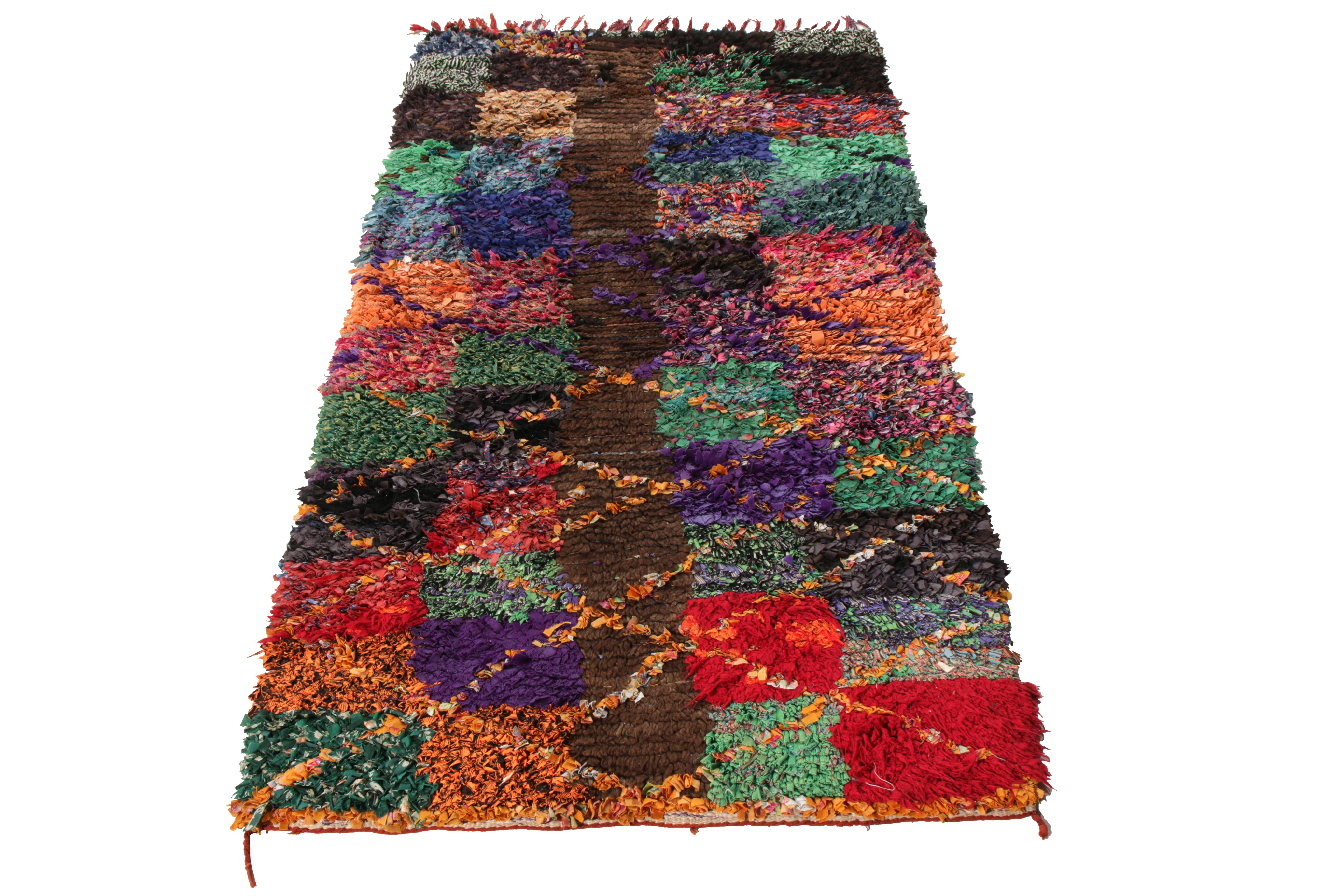 Hand knotted in Boucherouite wool & fabric, this 3x6 Berber runner belongs to Rug & Kilim’s discerning Moroccan rug collection. Originating from Morocco circa 1950-1960, the runner is created in a high pile featuring an incredible tribal- geometric
