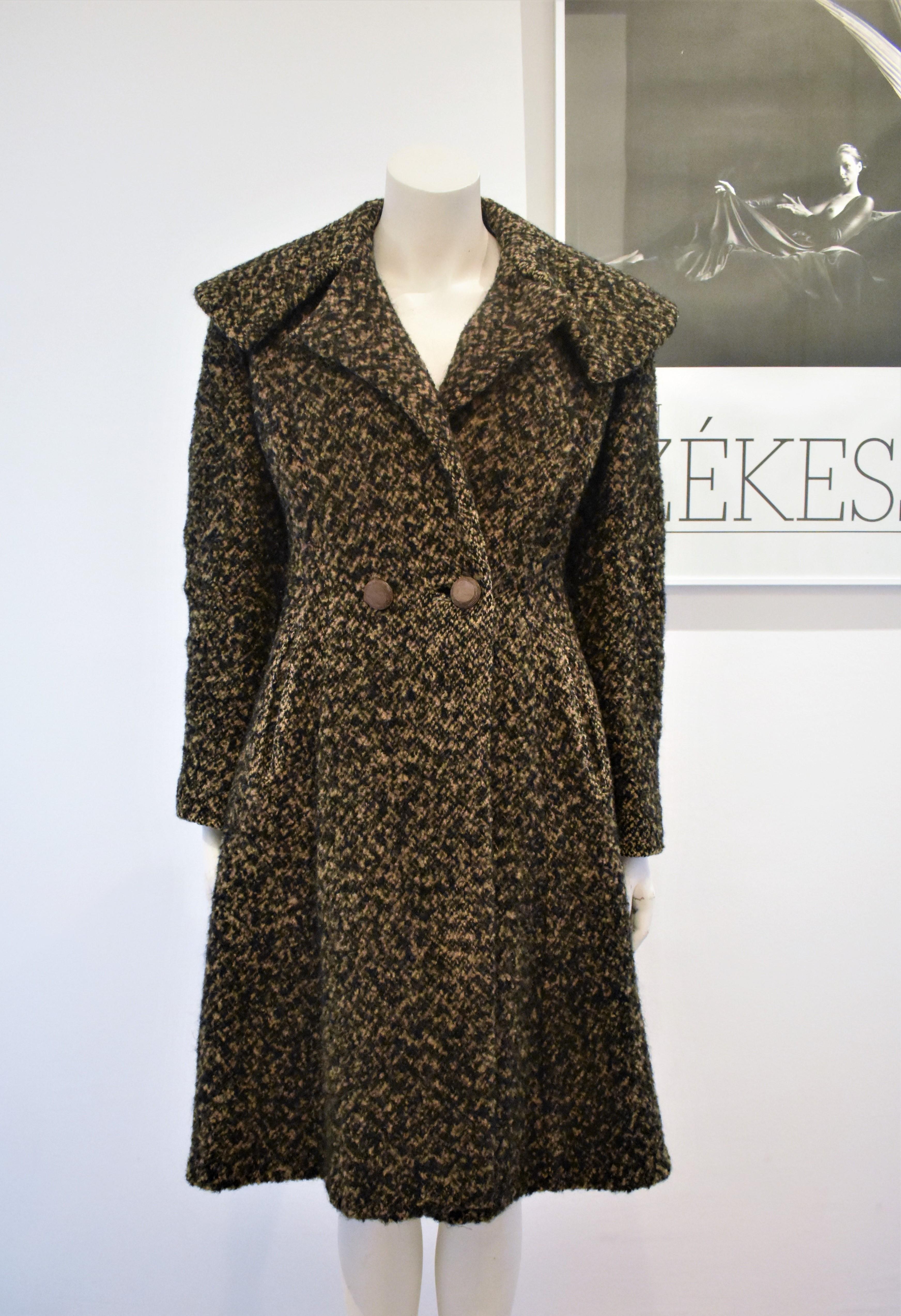 A beautiful vintage coat in Christian Dior's new look style. It is in good condition for its age and very heavy and warm.
