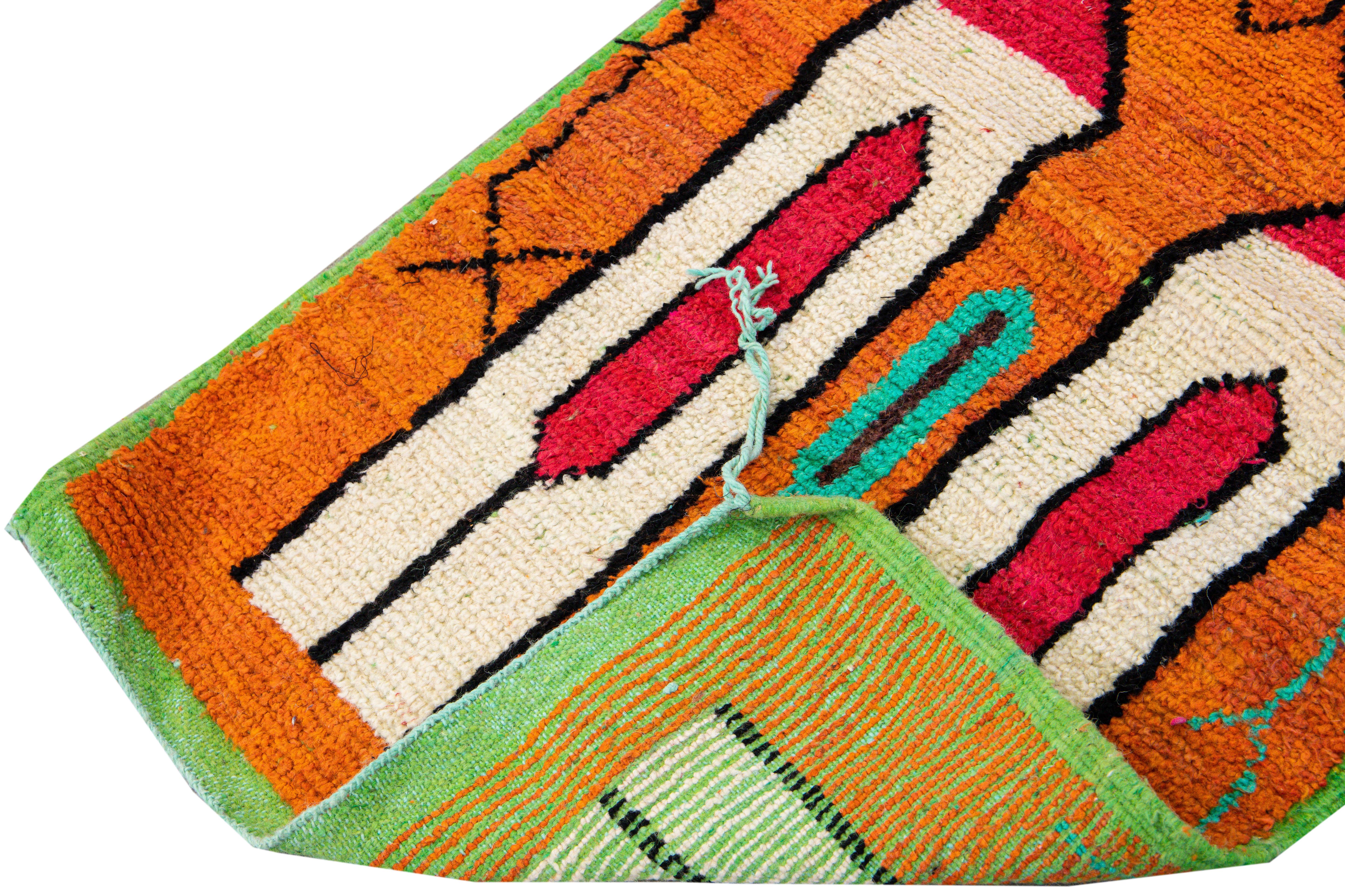Beautiful vintage Boujad Moroccan hand-knotted wool rug with the orange and green field and accent. This Moroccan runner has bright multi-color accents and teal fringes in all-over multi patterns with different Berber symbols and geometric-based