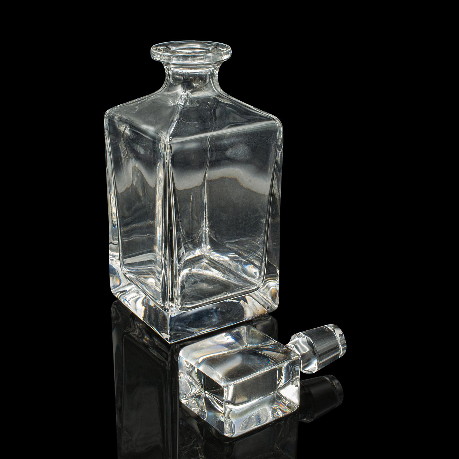 
This is a vintage whiskey decanter. An English, glass spirit vessel, dating to the mid 20th century, circa 1950.

Pleasingly broad glass helps create a distinctive 'ice block' appearance
Displays a desirable aged patina and in good order