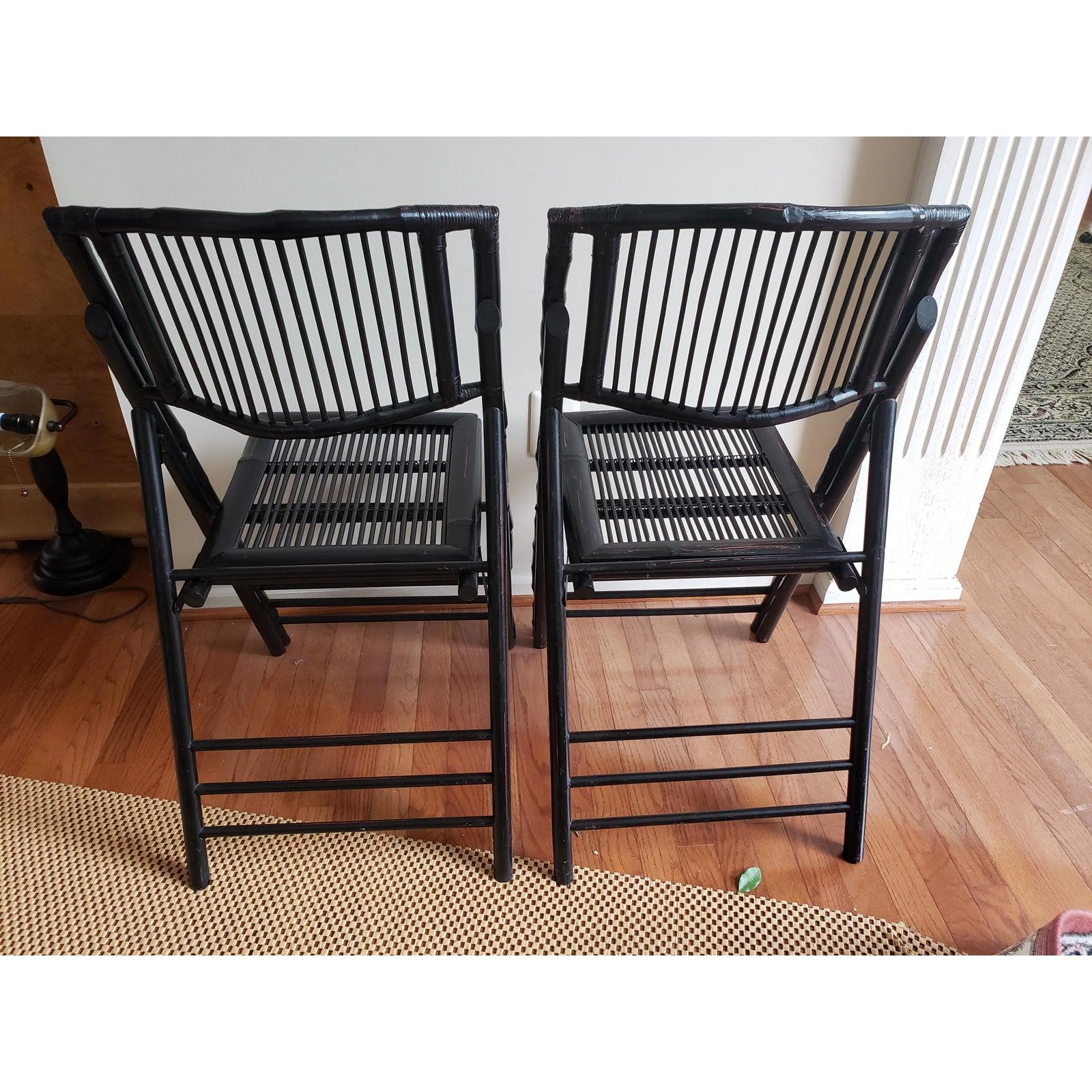 A pair of 1970s tortoise bamboo folding chairs in black. Good vintage condition. Measure 18