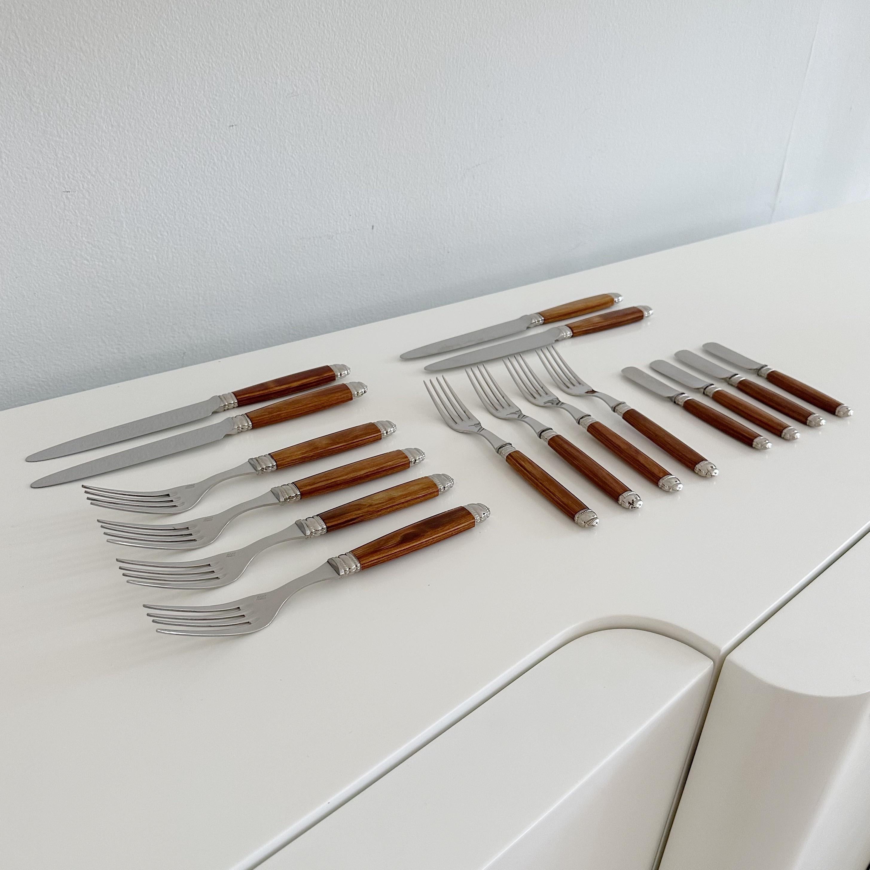 Set of Scof France 16 piece cutlery set. In the Reclaimer Rio pattern. Consisting of 4 dinner knives, four dinner forks, four salad forks and four bread knives. Stainless steel with mahogany color handles in excellent condition with original box.