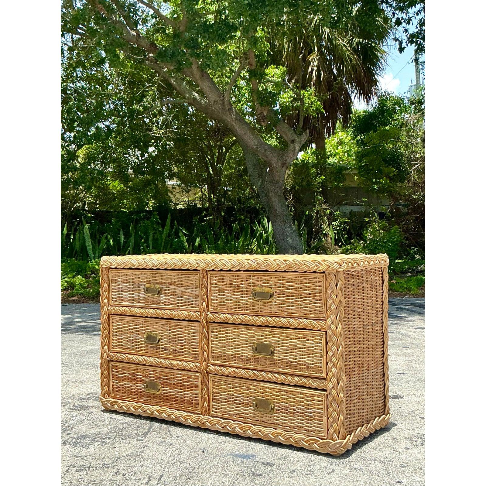 Embrace the relaxed elegance of island-inspired design with this stunning vintage braided rattan dresser. Expertly crafted from light, natural rattan, this piece showcases beautiful woven textures, highlighted by distinctive braided trim detailing