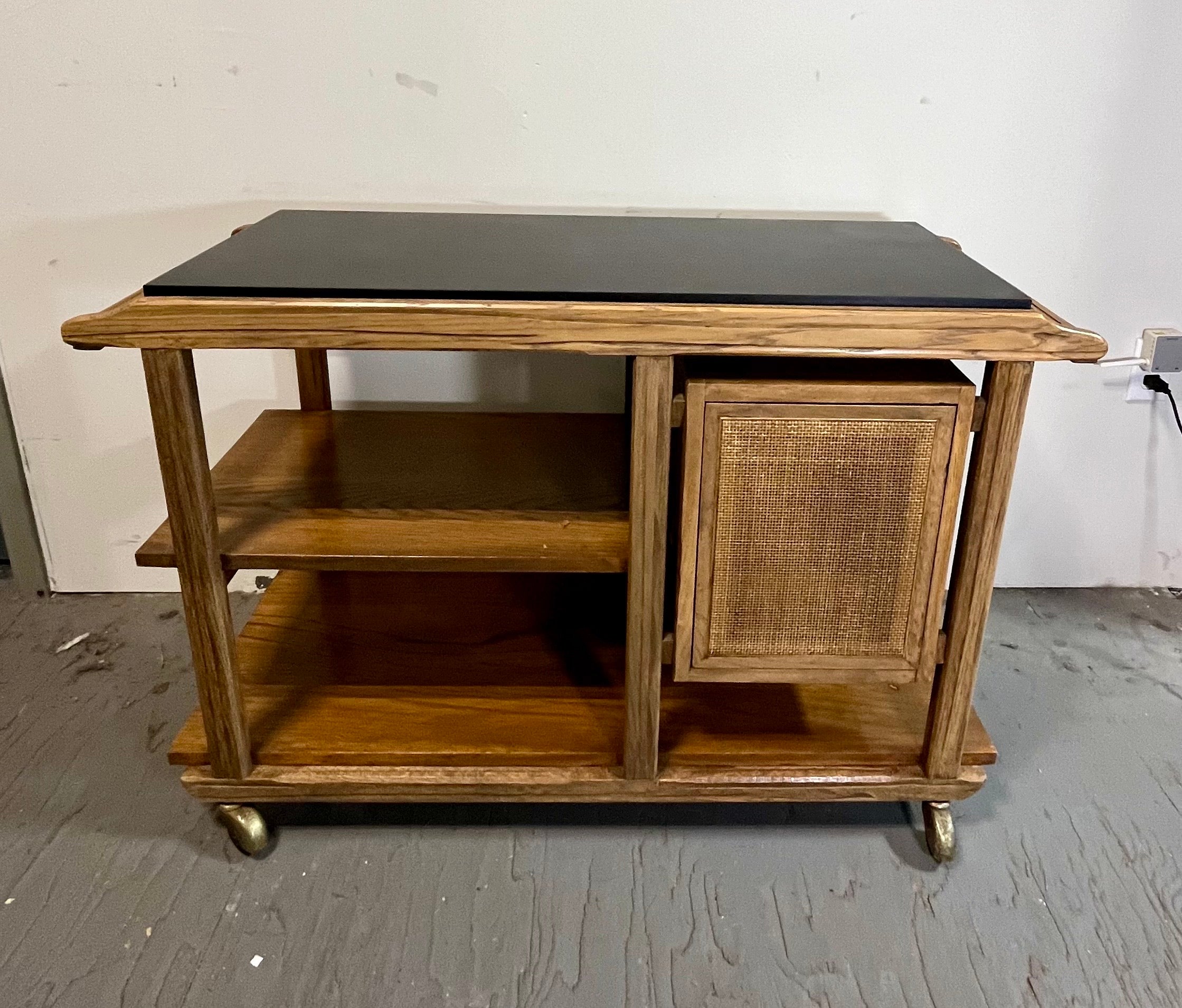 Beautiful unique Brandt Ranch Oak flip top bar cart. This serving cart is classic Ranch Oak. Cane front push cabinet along with mica flip top that doubles the size of serving area. 72