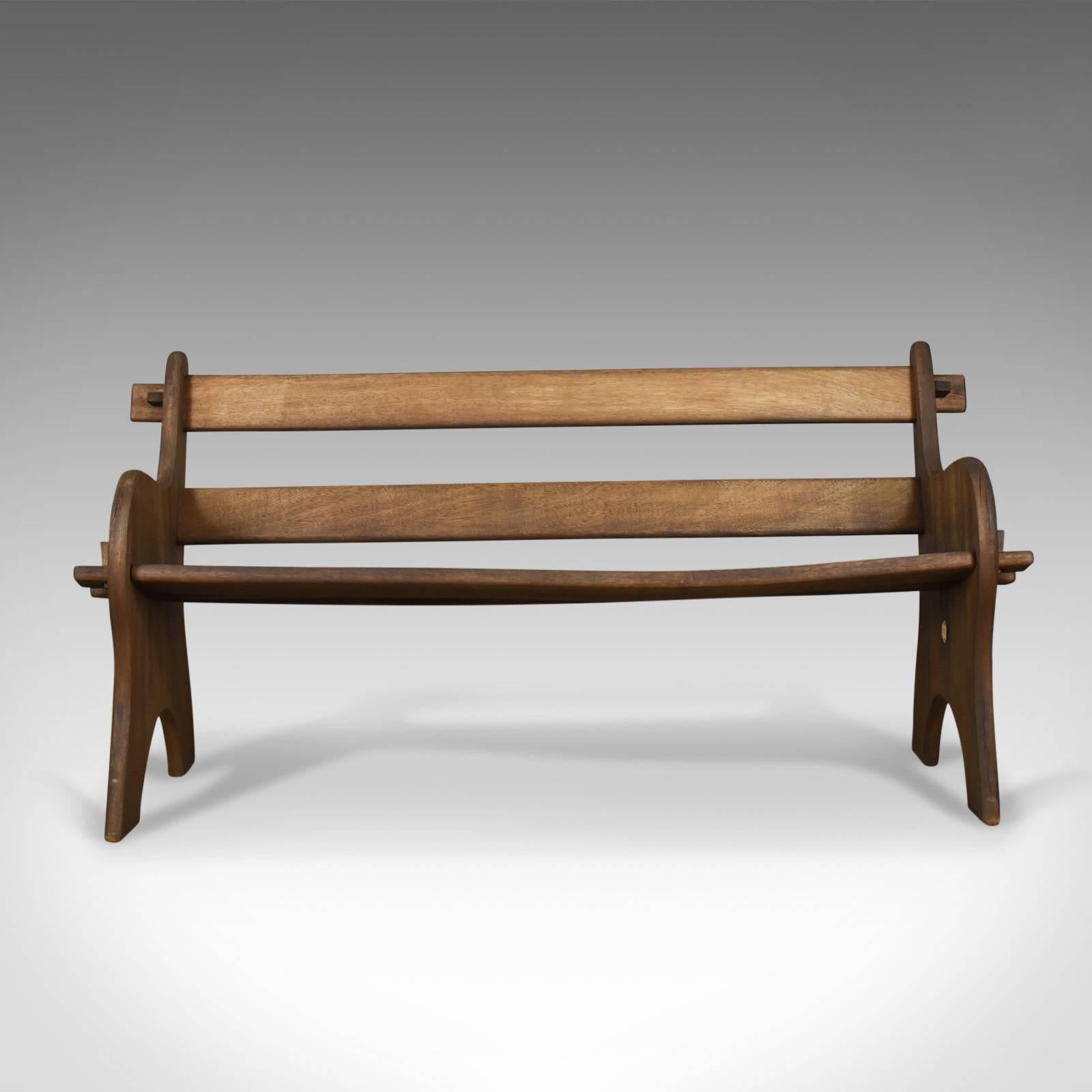 This is a vintage Branson Burbage bench, an English hardwood bench for outdoor or indoor use dating to the late 20th century.

Solid hardwood with a dark finish
Classic design with country character
Wedged design for easy assembly, simply store