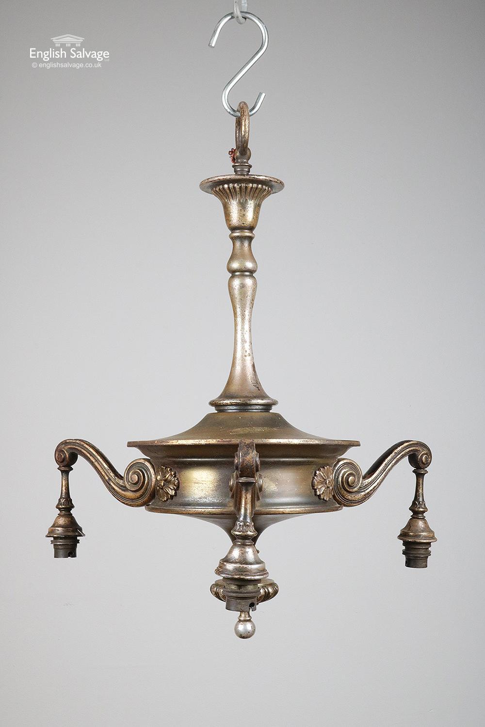 Attractive reclaimed three-arm pendant ceiling light. Well made with a decent weight to it. Lovely detailing throughout with scrollwork and floral cartouches. There is some wear and discoloration to the brass as shown in the photos. Standard bayonet