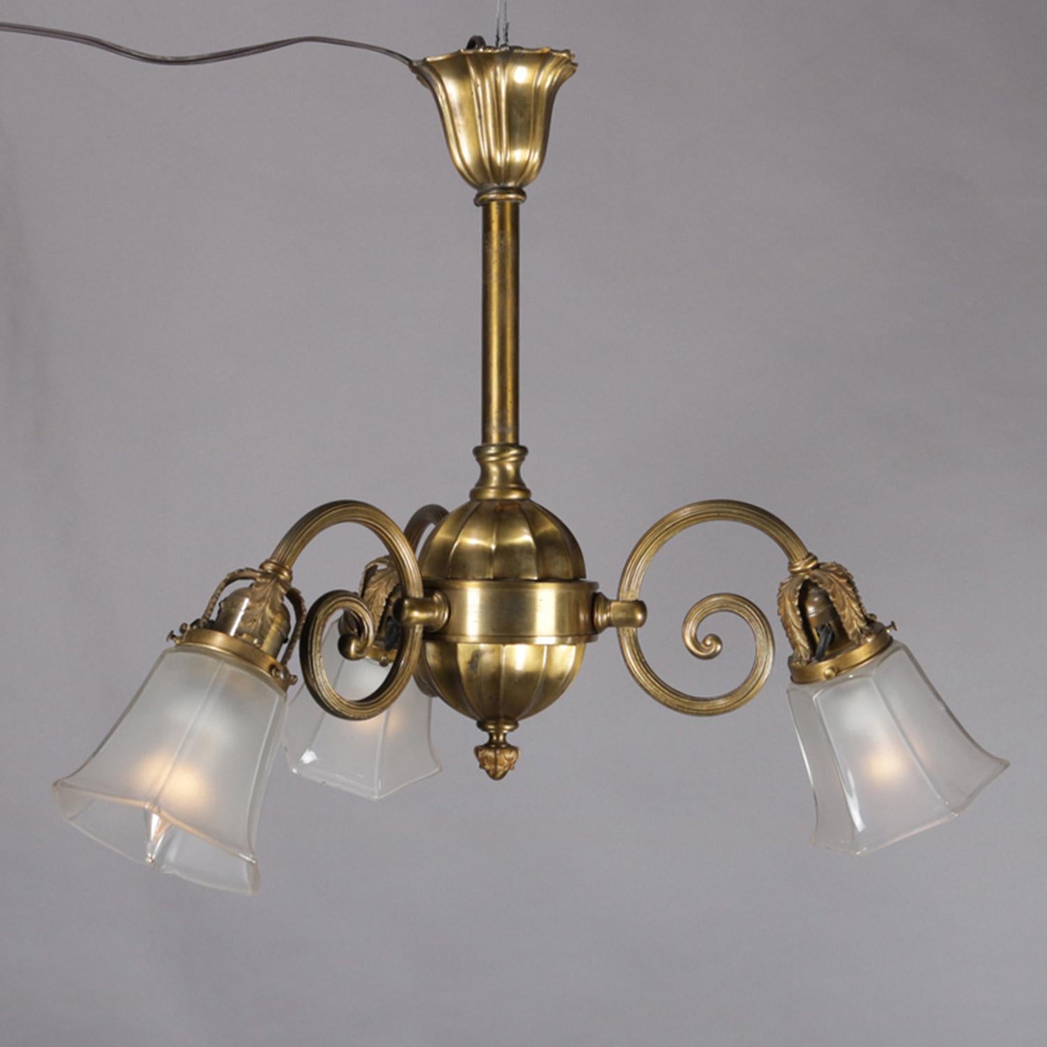 A vintage branch chandelier features brass frame with column terminating in faceted pendant and having three scroll arms with lights having frosted glass shades, circa 1920.

***DELIVERY NOTICE – Due to COVID-19 we are employing NO-CONTACT PRACTICES