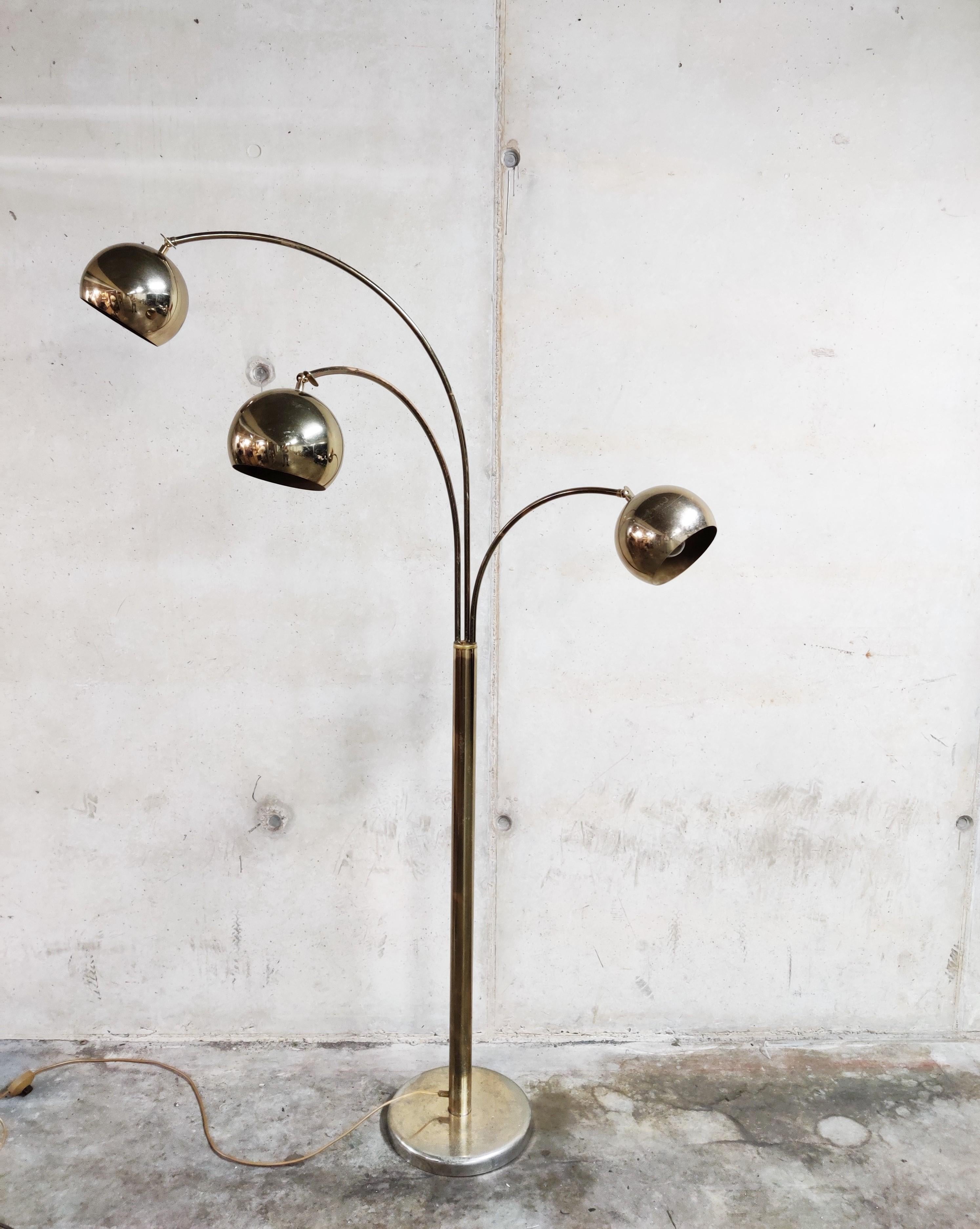 Vintage brass three lightpoint 'arc' floor lamp.

The brass globes are articulated and the arms of the lamp can be moved in order to position the lightpoints as desired.

The lamp has age wear and patina on the arms and base, but still look