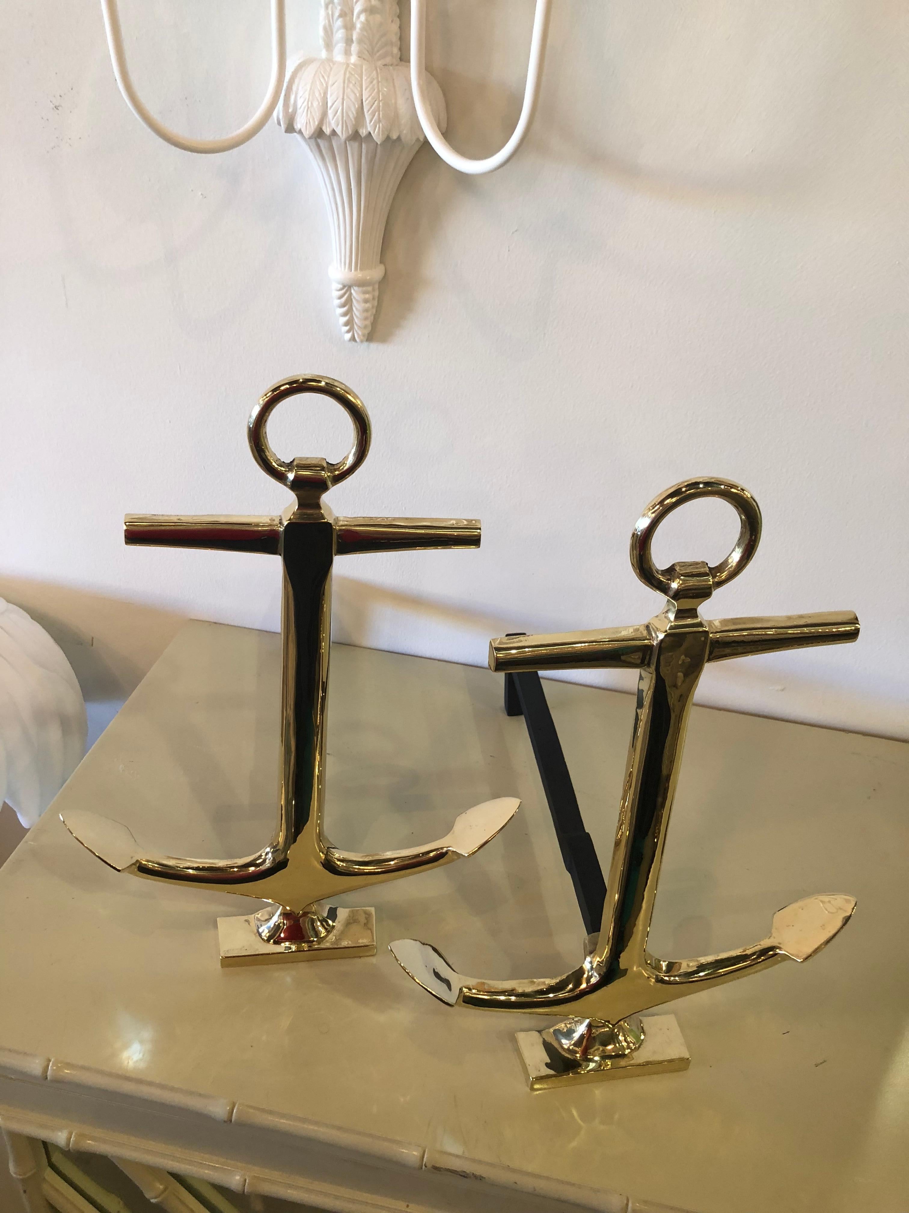 Professionally restored and polished brass anchor andirons, a pair.