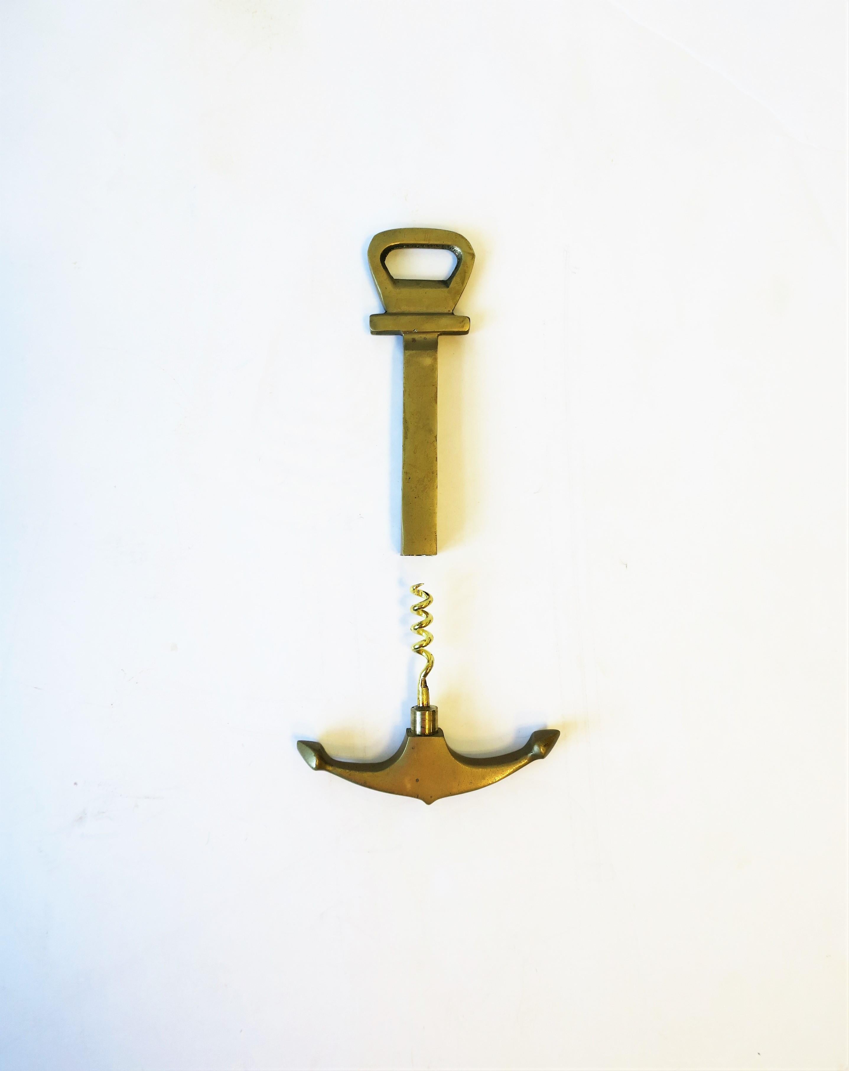 A vintage solid brass anchor wine and bottle cap opener Auböck style, circa mid-20th century. A pull back of anchor reveals corkscrew. Piece may be Italian, German, or Austrian. Dimensions: 3.5