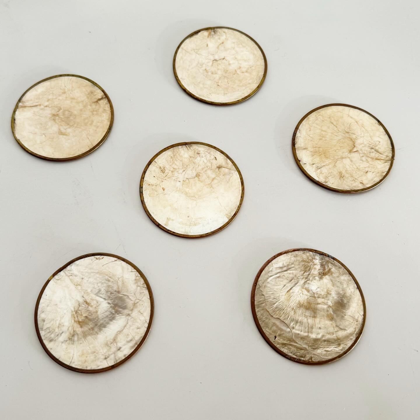 Indulge in the elegance of Vintage Brass and Capiz Shell Coasters on Cork, a set of 6 that blends sophistication with functionality. These coasters combine the warmth of brass with the iridescence of capiz shell, offering a non-slip, stylish