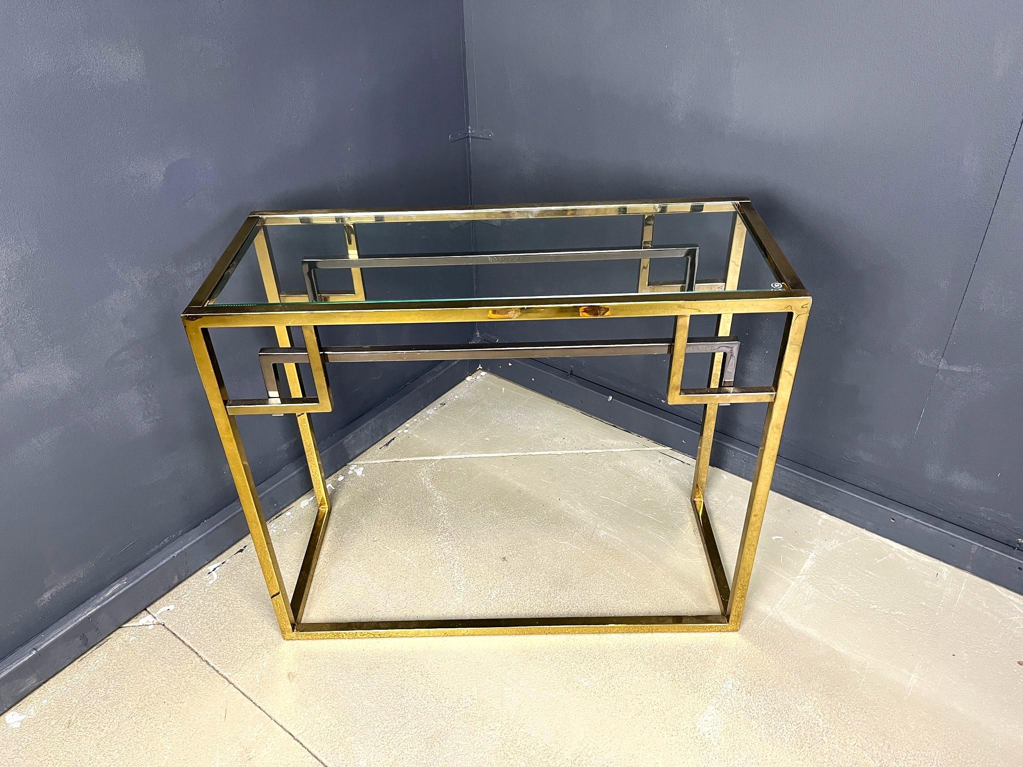 Vintage brass and chrome console table Produced by Belgochrom.

Clear glass top

Good condition with normal age related wear/patina

1970s - Belgium

Dimensions:
Height: 80cm
Width: 96cm
Depth: 40cm

Ref.: 2504170102

*All images are always part of