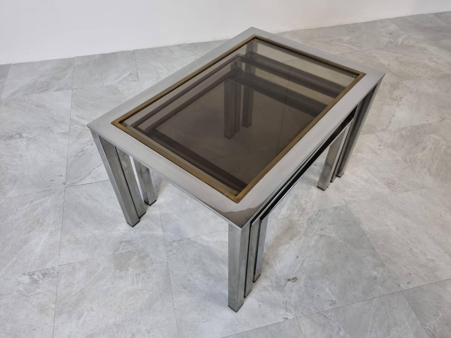 Vintage brass and chomr nesting table with smoked glass top.

Mixes with a lot of styles.

Seventies glam

Dimension highest table:

Height: 45 cm / 17.71