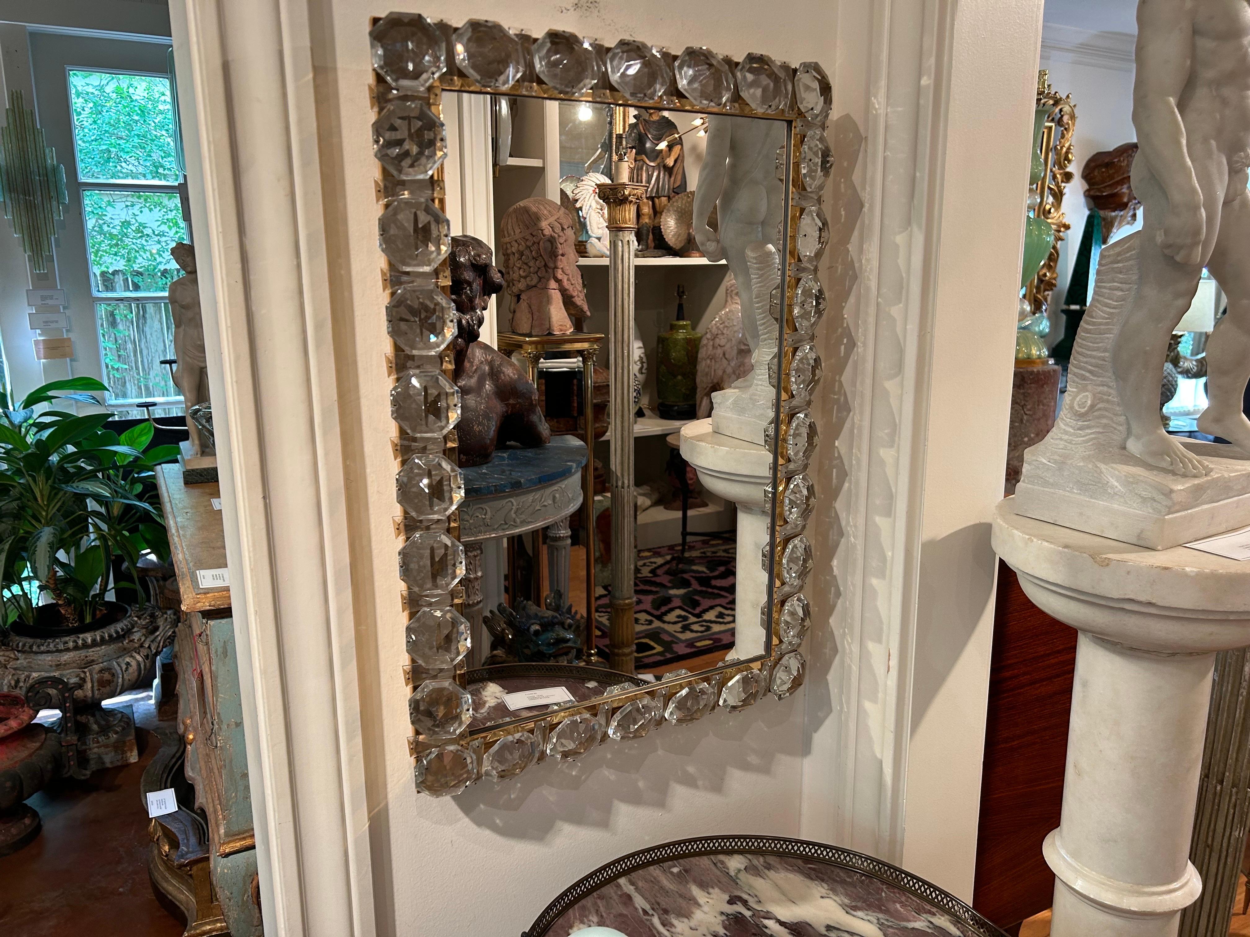 Vintage Brass And Crystal Mirror By Palwa.
This expertly executed Hollywood Regency mirror has a beautiful thick brass frame with huge 2.5 inch crystals around the perimeter.
Our stunning crystal mirror is the perfect candidate for a glamorous