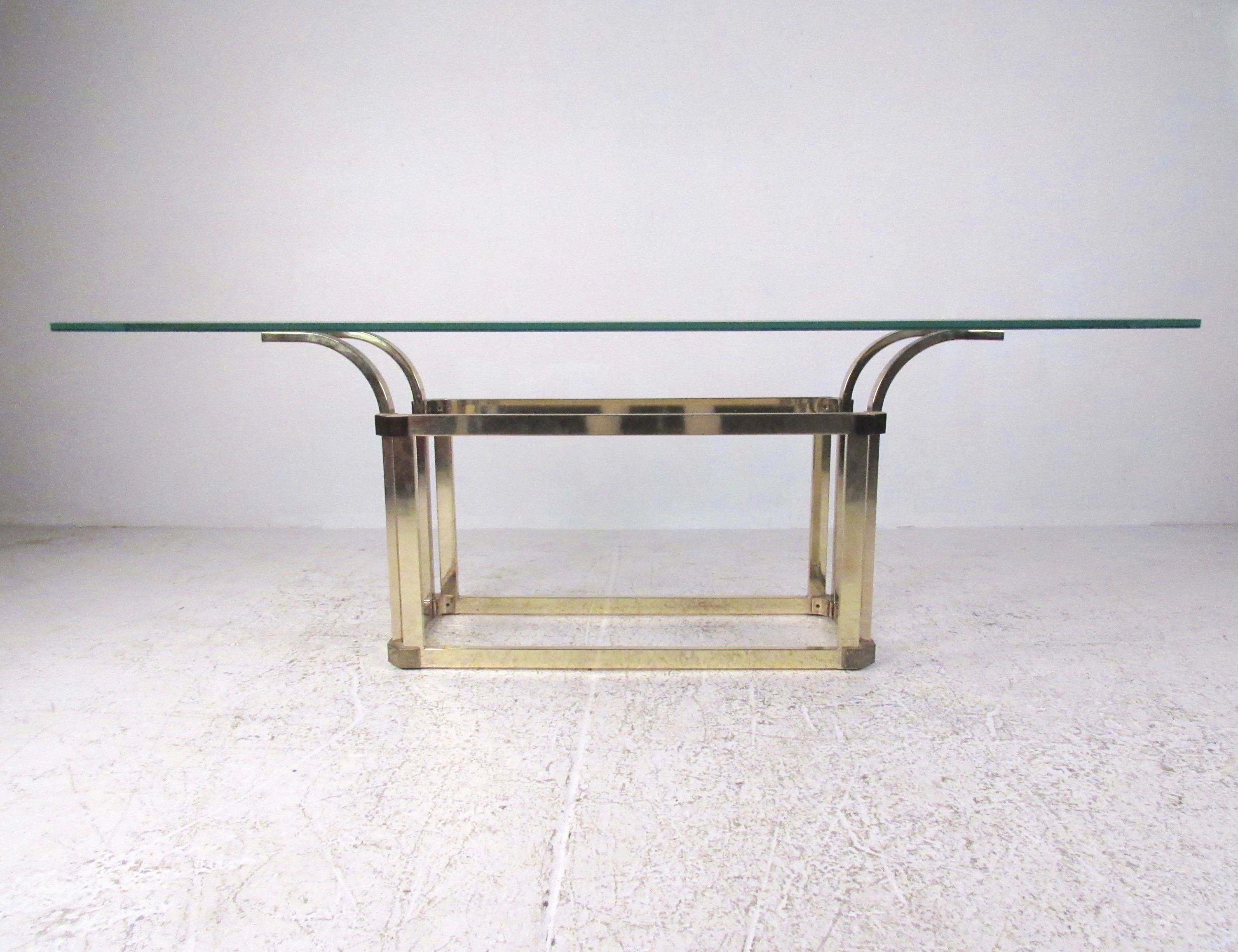 This oversized vintage brass sofa table features a midcentury-style brass base with a thick beveled glass top. Please confirm the item location (NY or NJ).