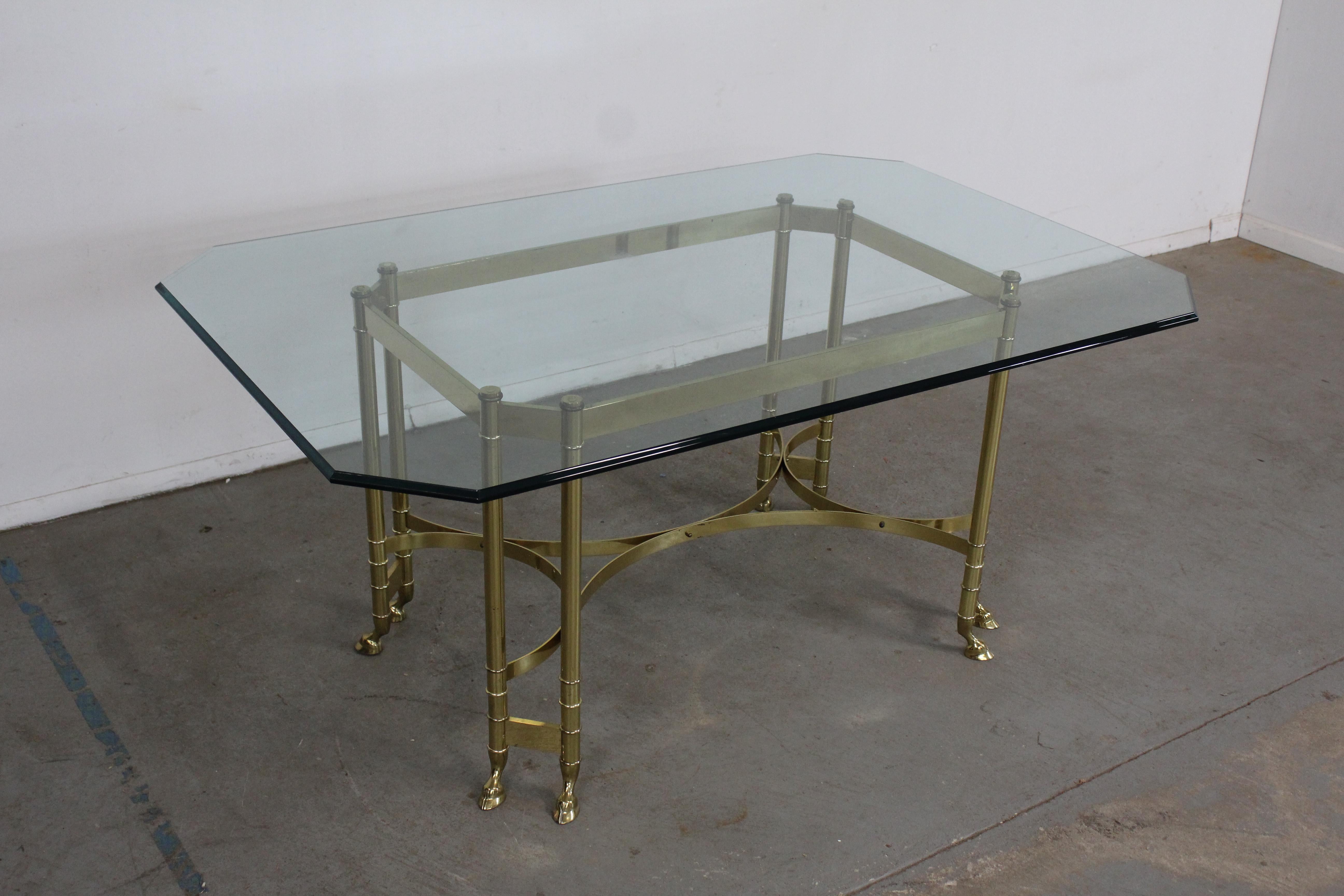 Vintage brass and glass Jansen style hoof foot dining table
Offered is a beautiful vintage brass and glass Jansen style hoof foot dining table. It is made of heavy brass. Features a 1