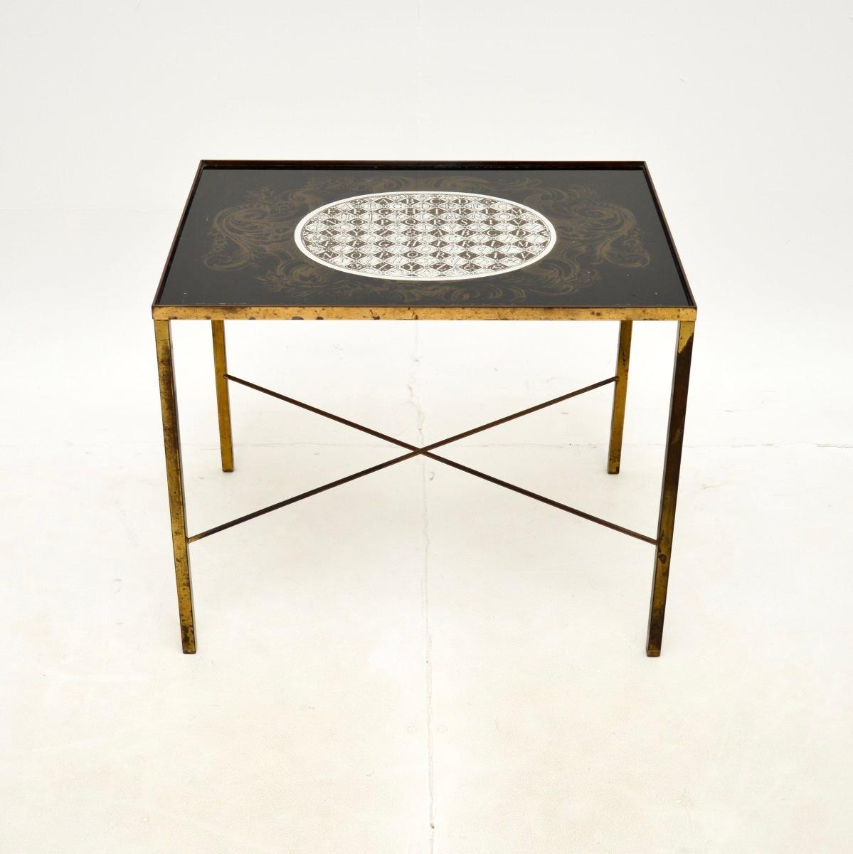 A stylish and very well made vintage brass and glass side table. This was made in England, it dates from the 1960’s.

The quality is fantastic, this is sturdy and well built. It is a lovely size, with a inset decorative glass top, it stands on a