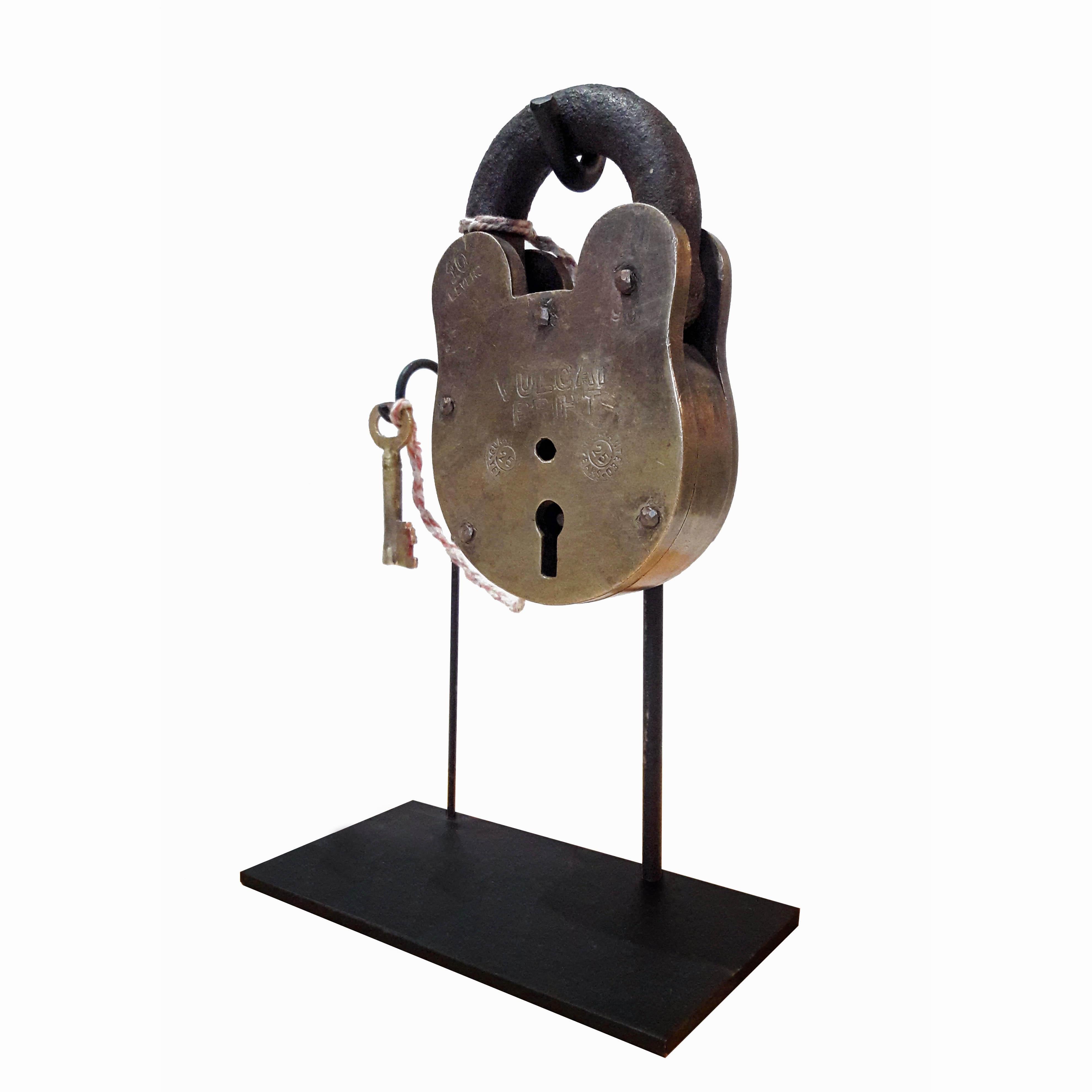 A large padlock hand-cast in solid brass and iron. Early 20th century.
From the Vulcan Bright maker, it has copper rivets and 10 levers. 
Comes with original skeleton key. Sold as a decorative / collector's item, but the padlock is fully